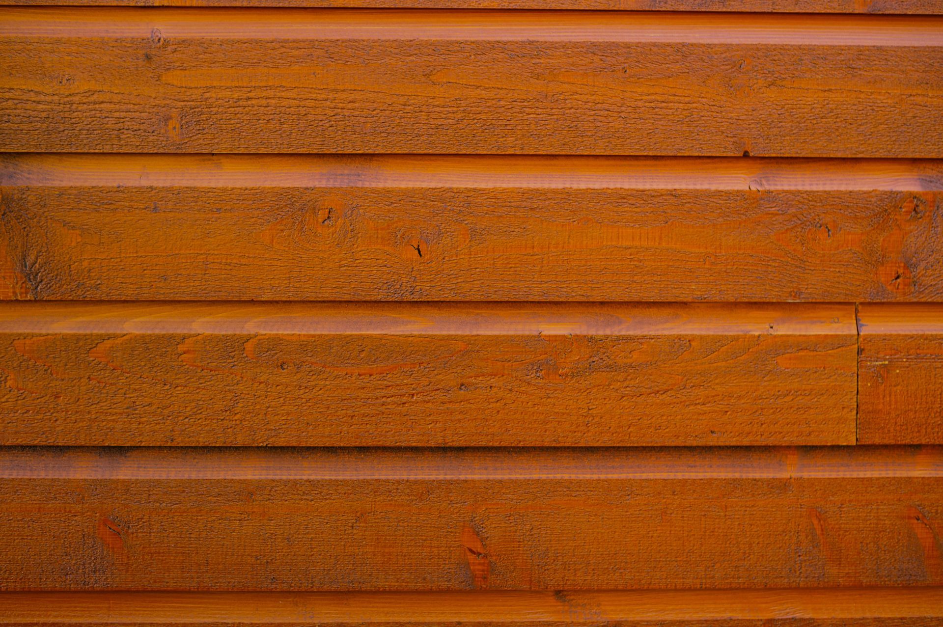 A close up of a rusty metal surface with a wooden texture.