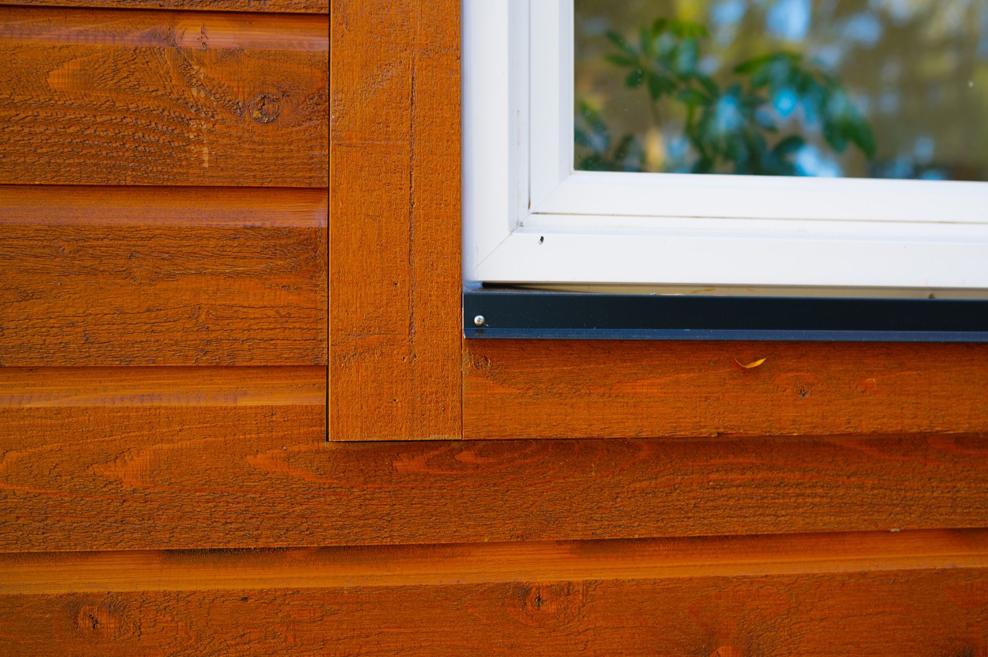 A close up of a window on a wooden house.