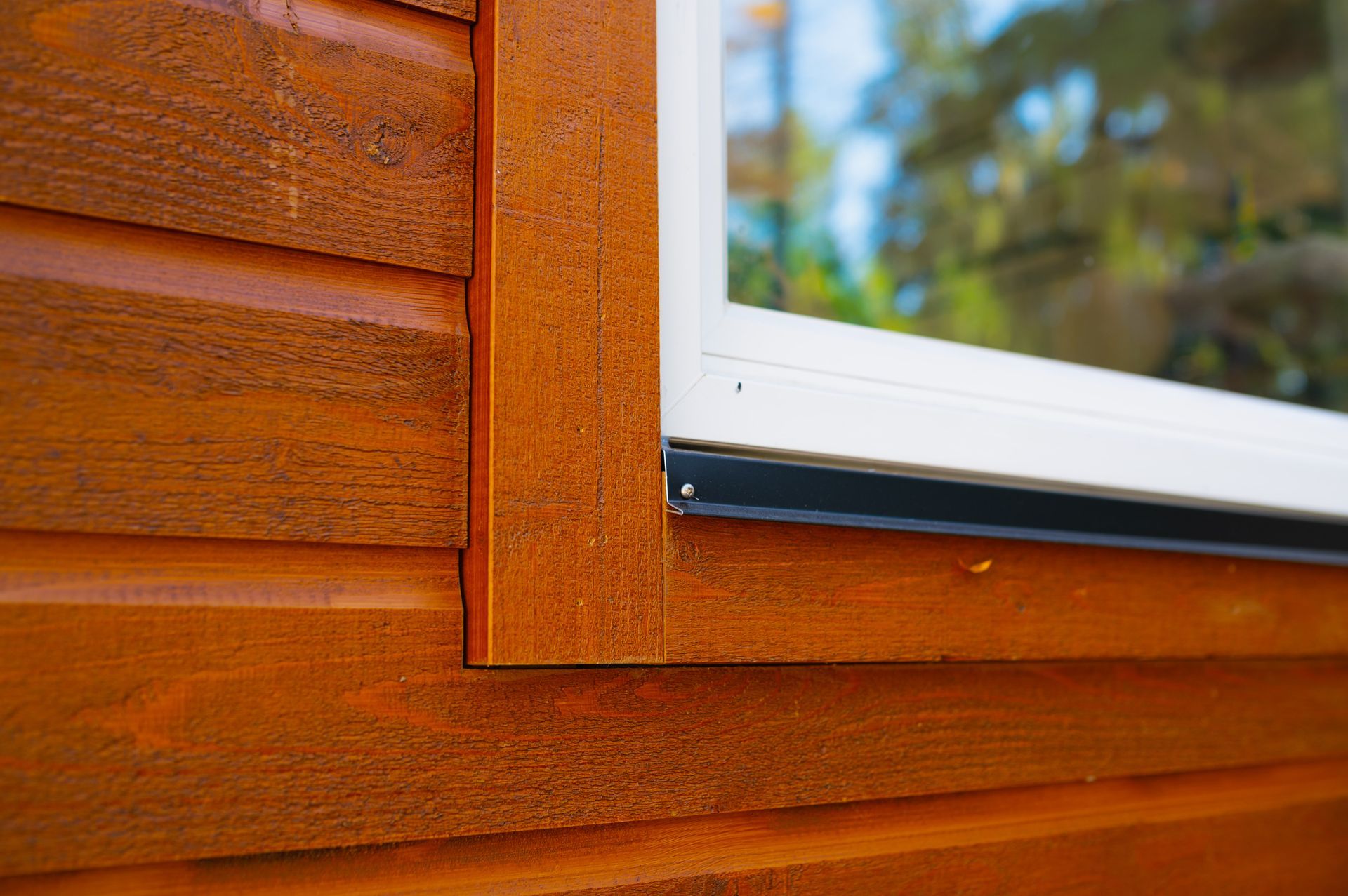 A close up of a window on a wooden house.