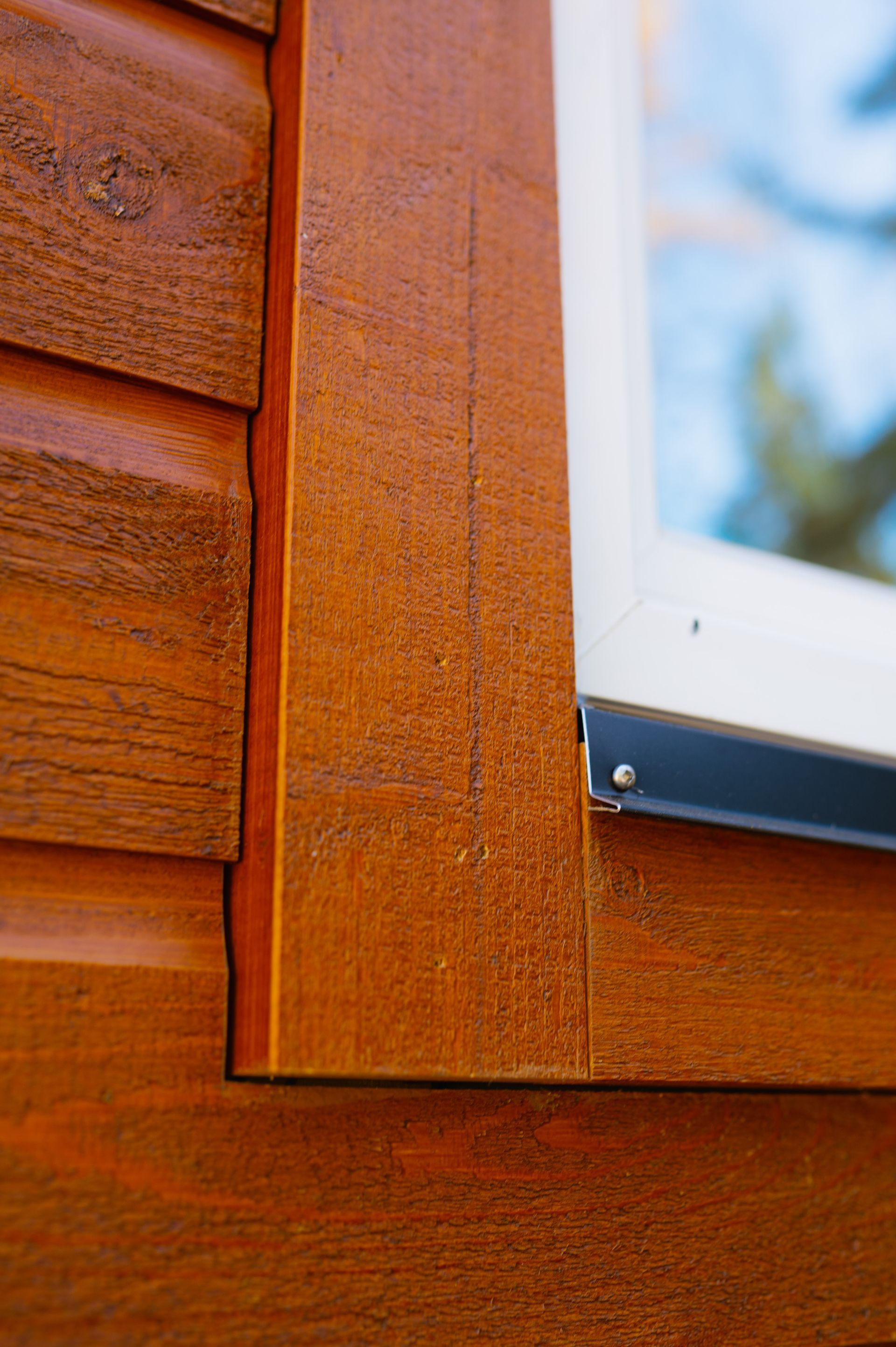 A close up of a wooden building with a window.