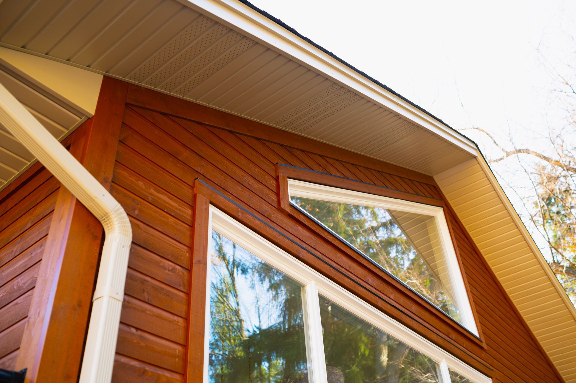 A house with a lot of windows and a wooden siding.
