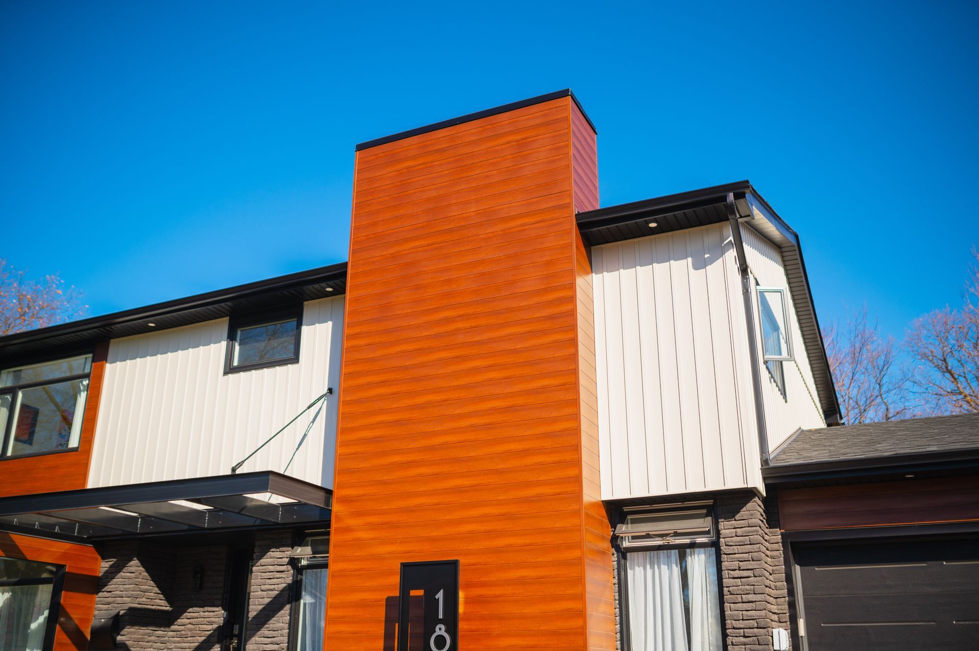A house with a large chimney on the side of it.