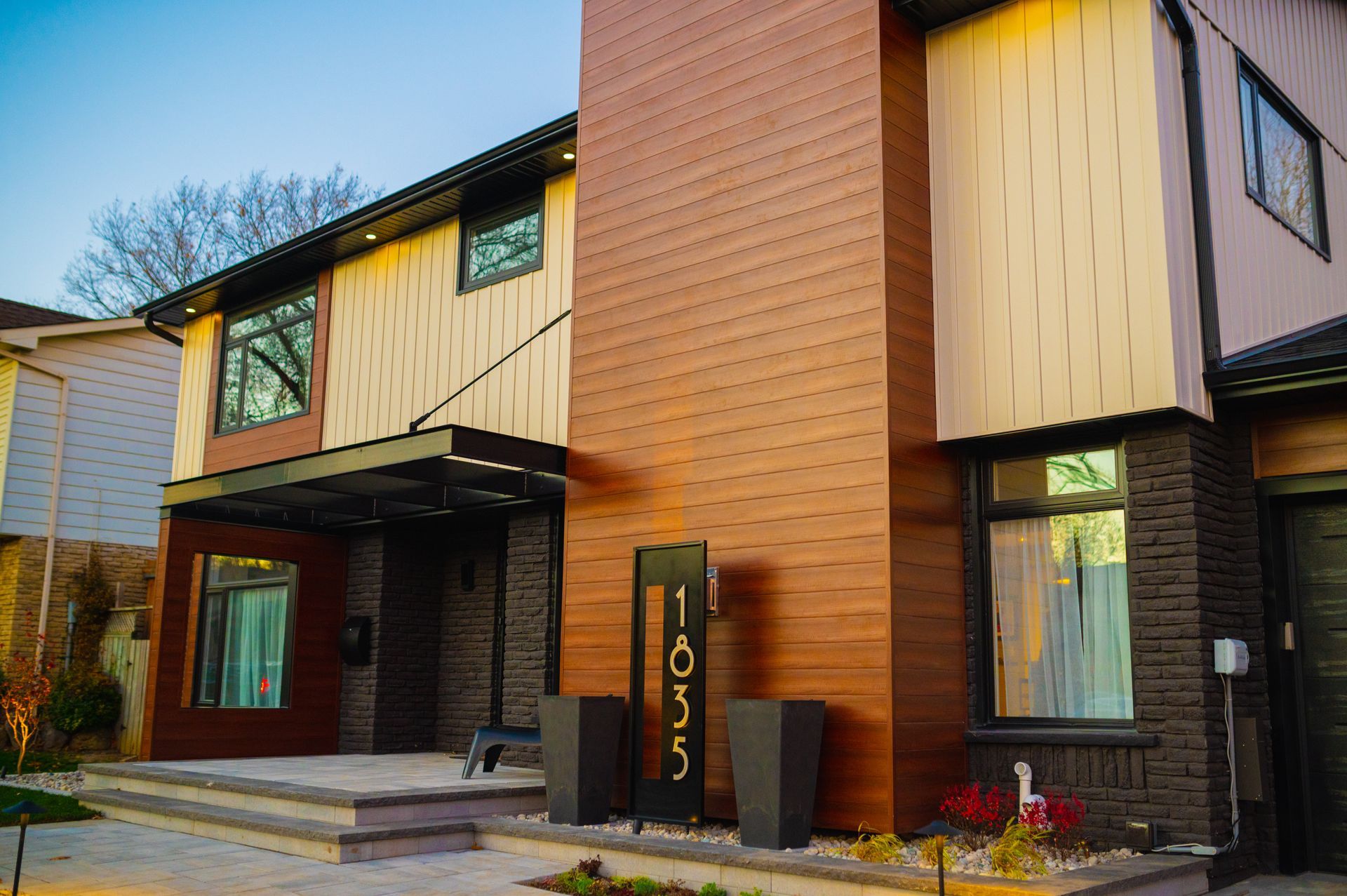 A house with a lot of windows and a sign that says 1055