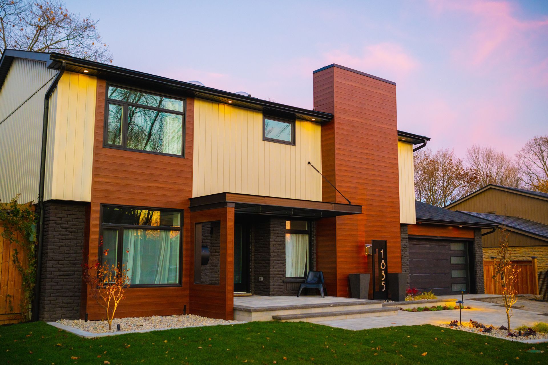 A large house with a lot of windows and a chimney on the roof.