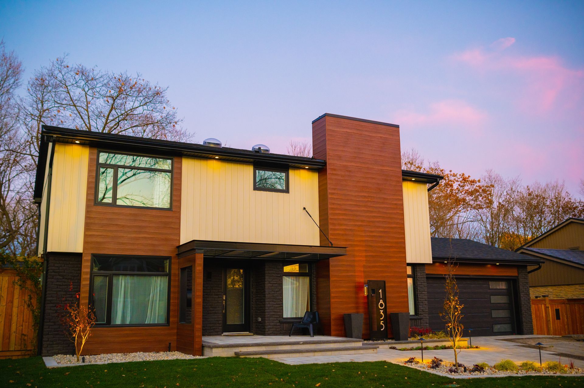 A large house with a lot of windows and a chimney