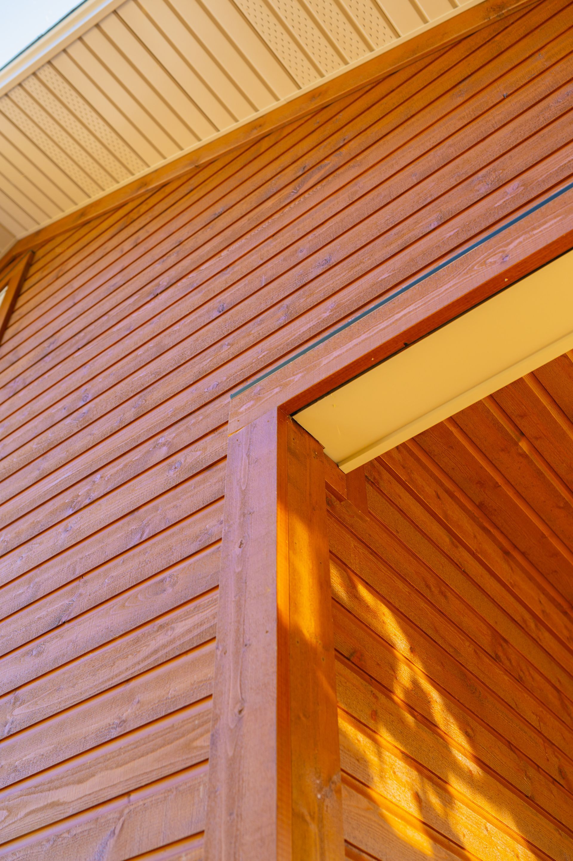 A close up of a wooden house with a door and a window.
