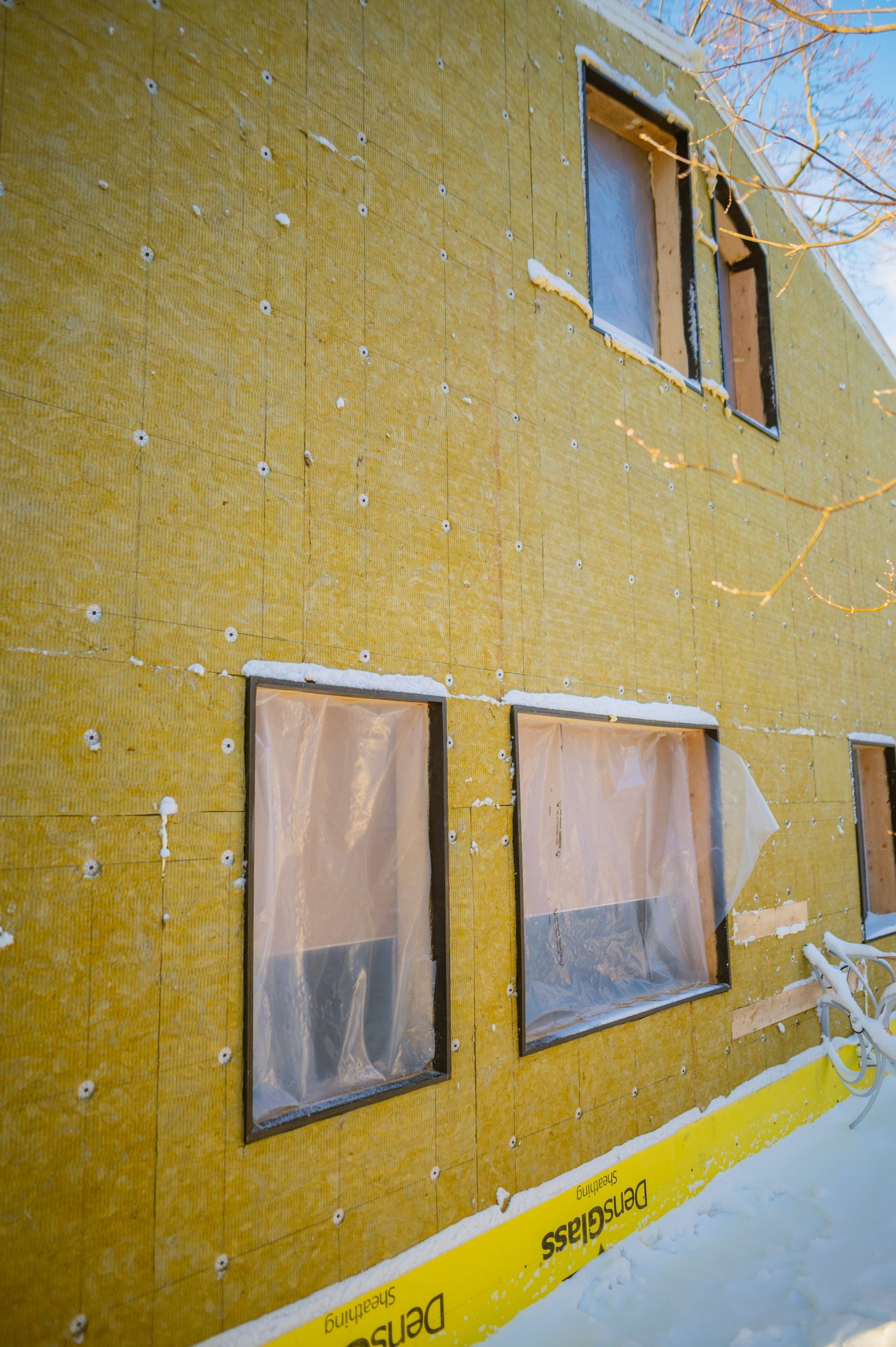 A house is being built with a lot of insulation and windows.
