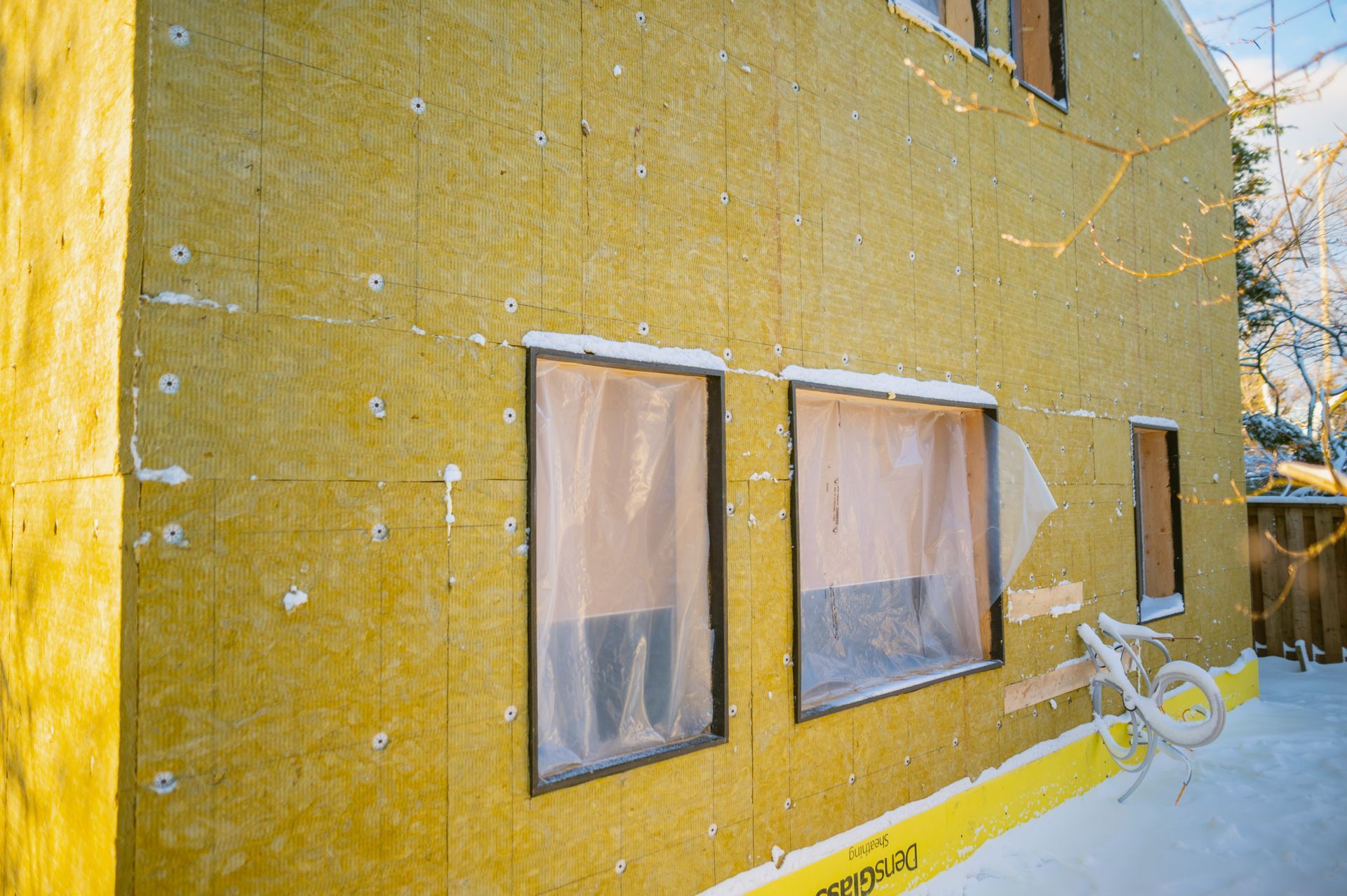 A yellow building with a bicycle parked in front of it.