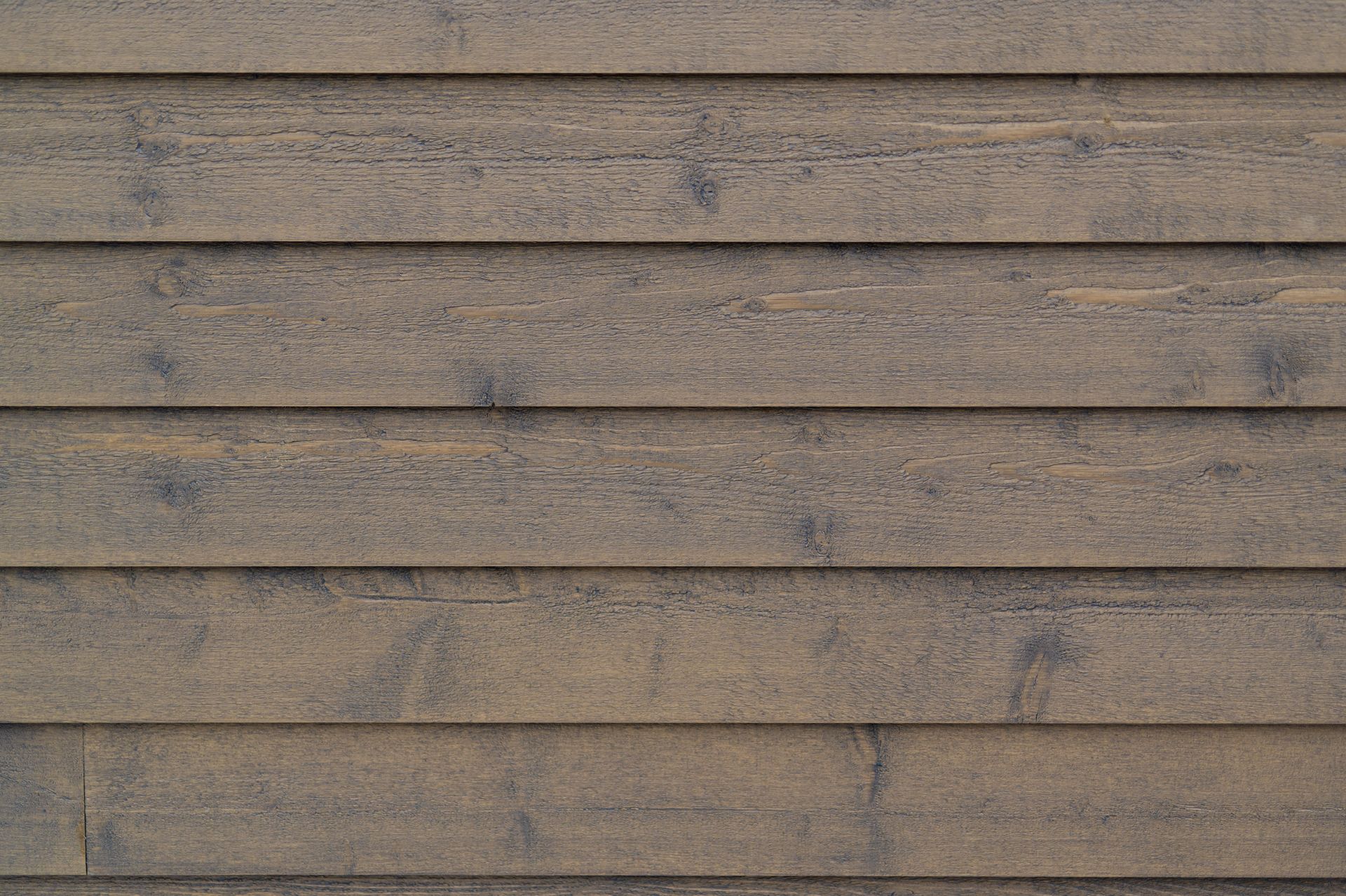 A close up of a wooden siding on a house.