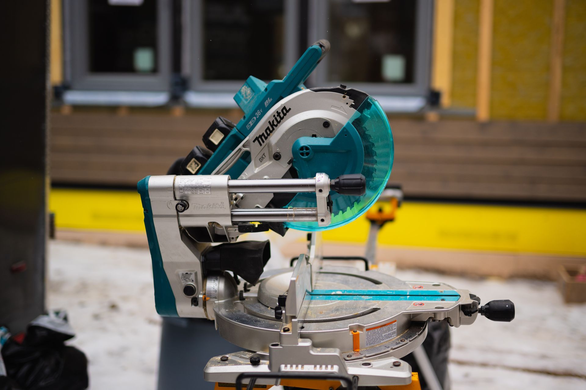 A circular saw is sitting on a table in front of a building.