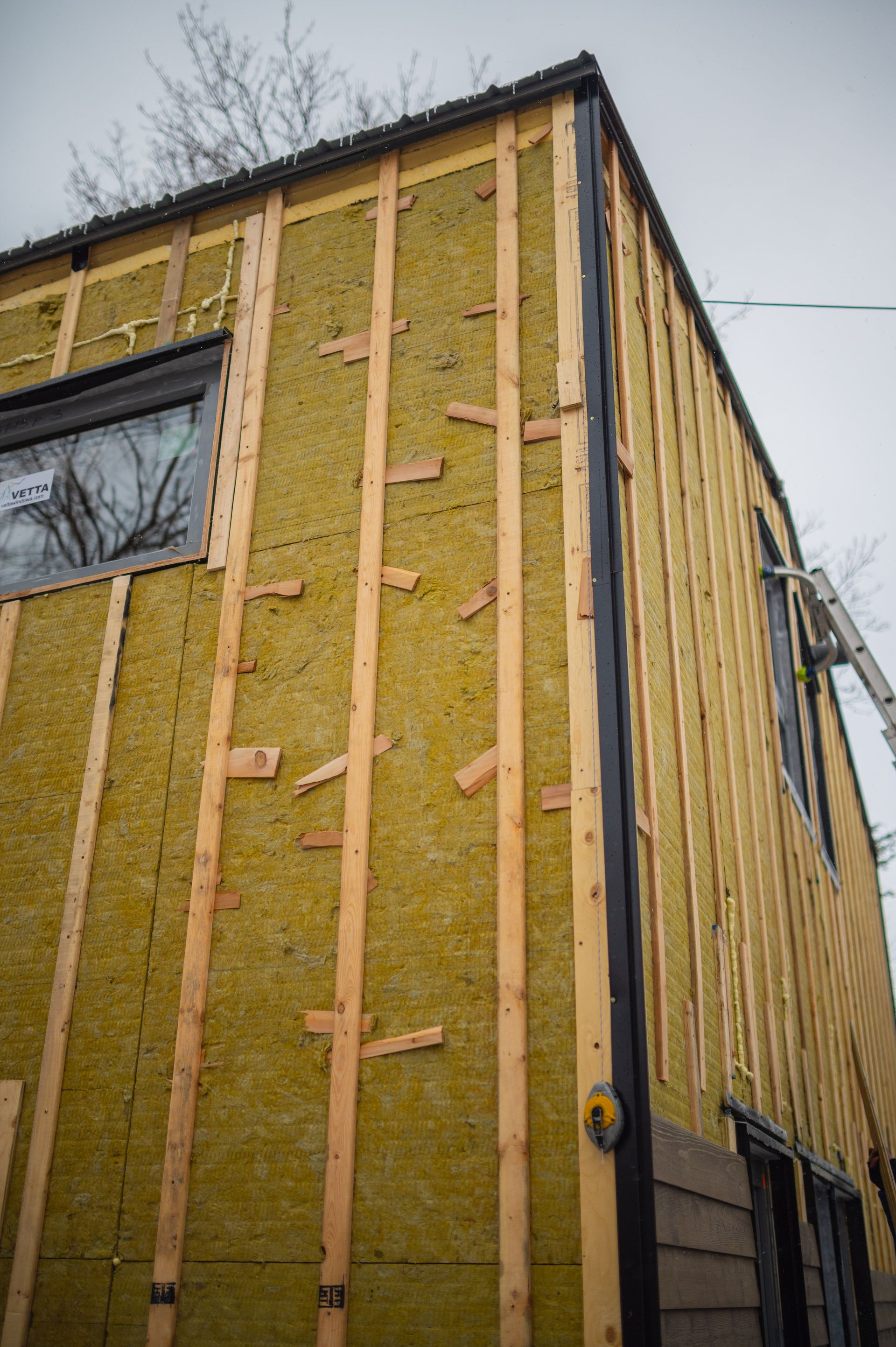 A building is being built with a lot of wood and rock wool.