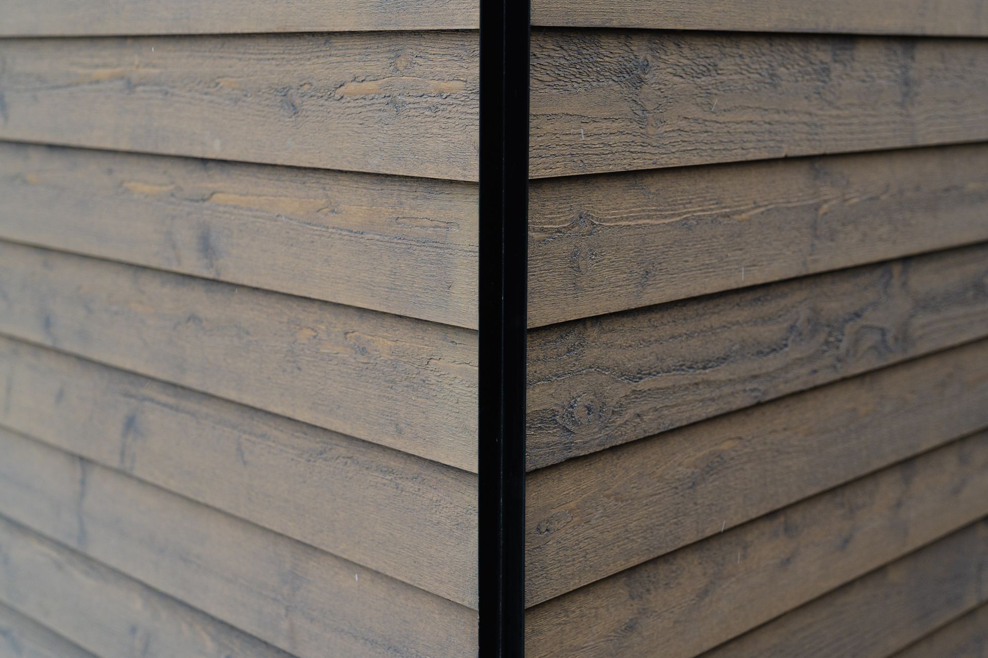 A close up of a wooden siding on a building