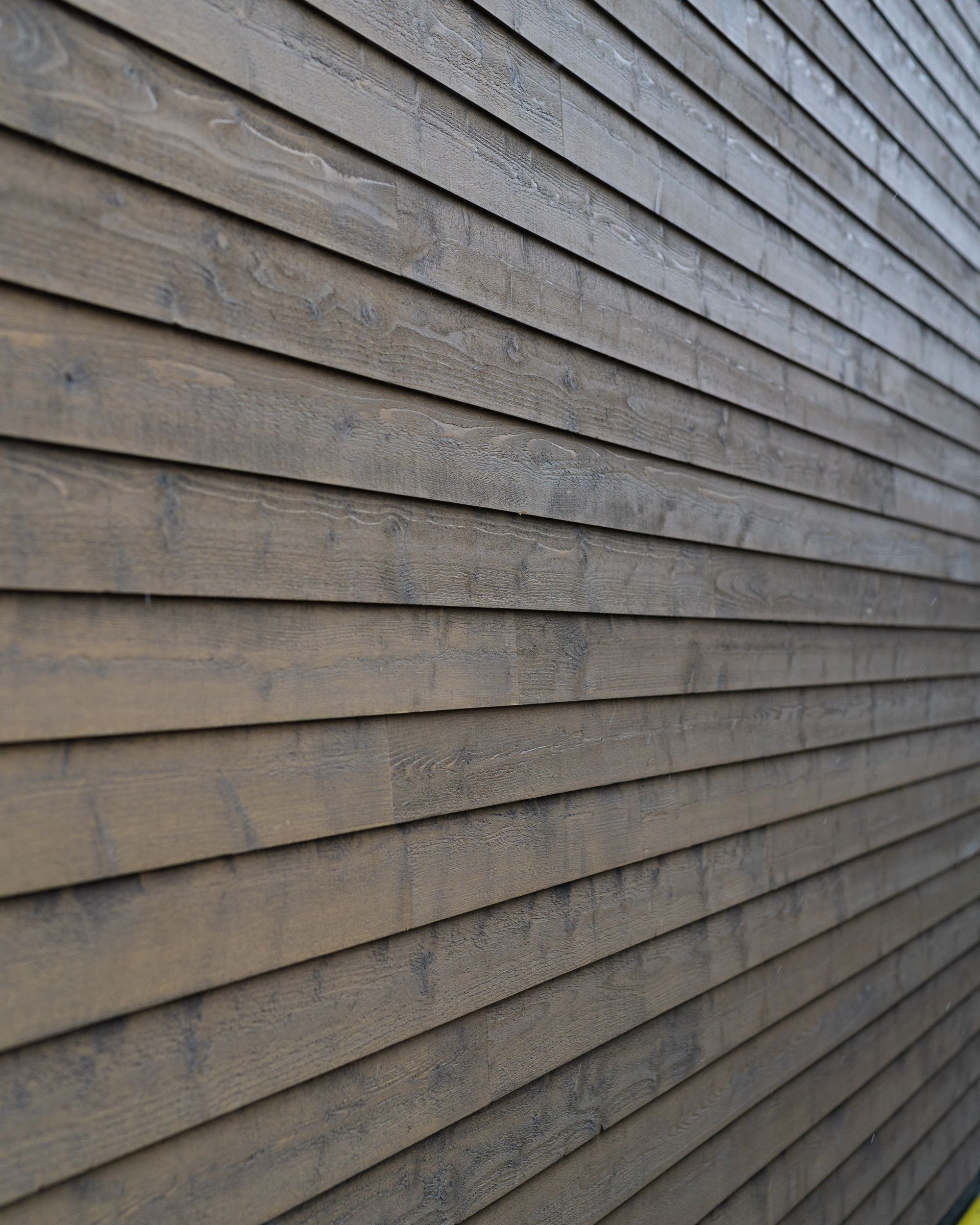 A close up of a wooden siding on a building