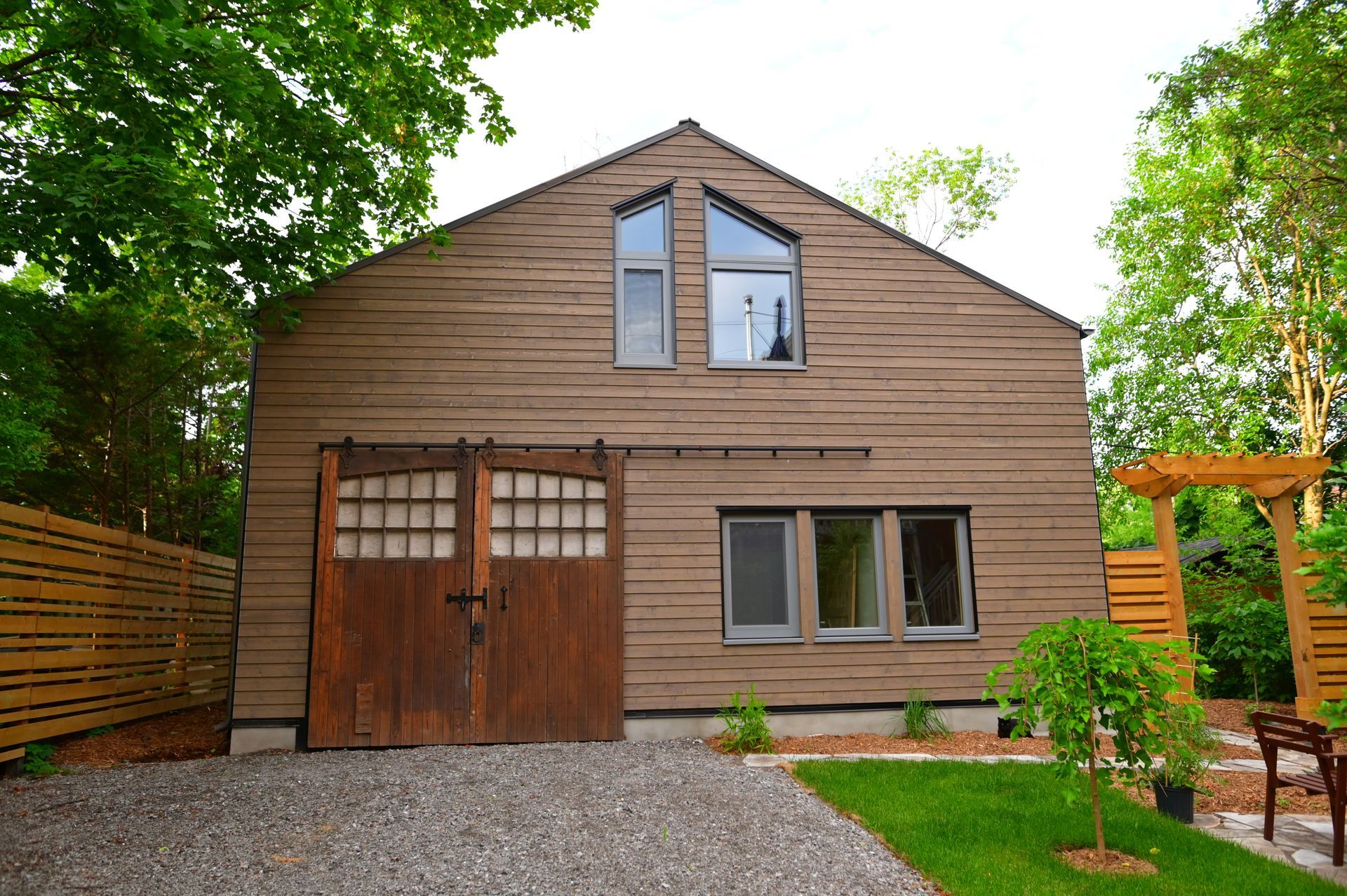 A brown house with a sliding barn door