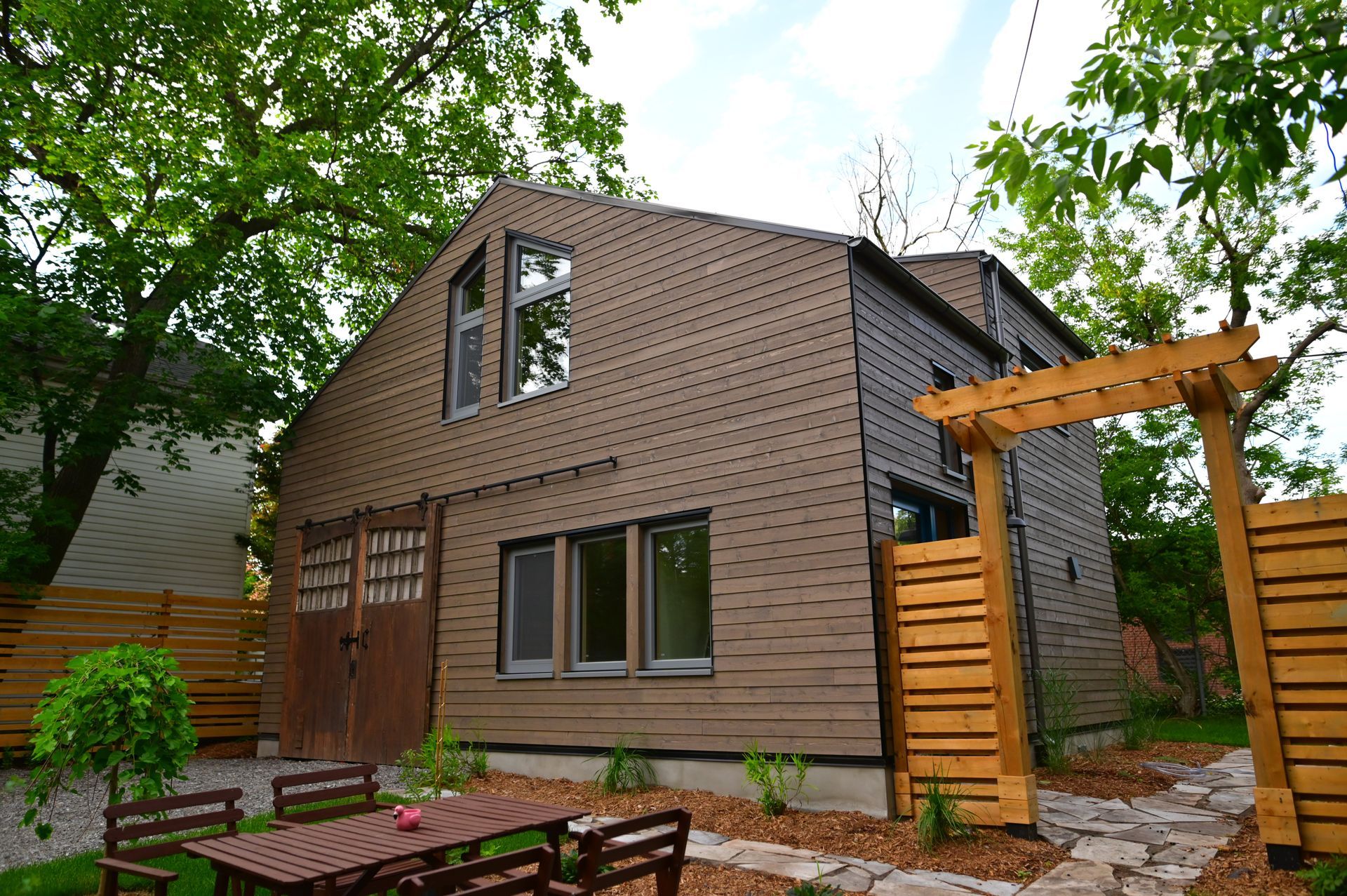 A house with a table and chairs in front of it