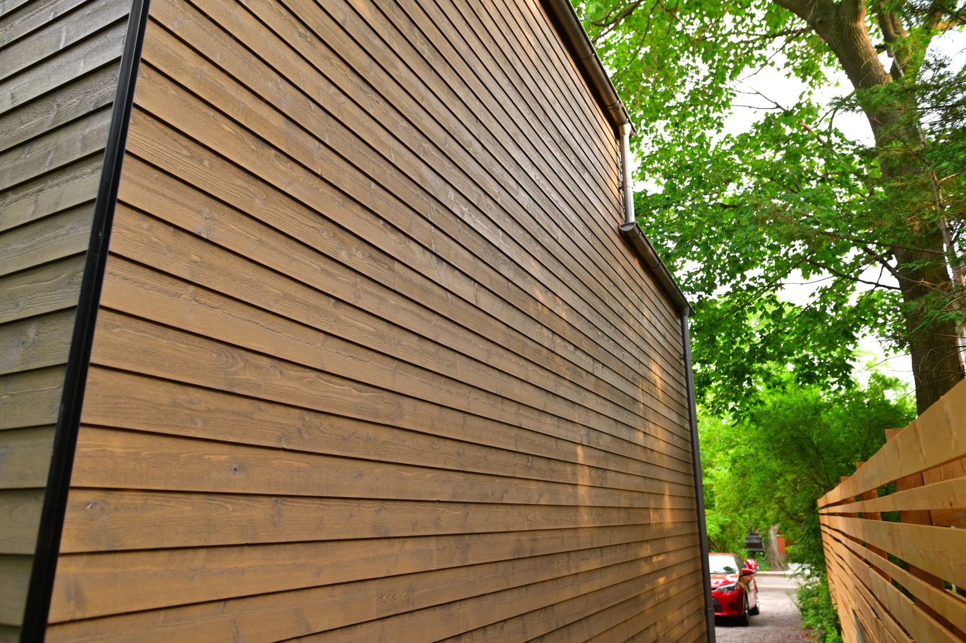 A house with a wooden siding and a wooden fence