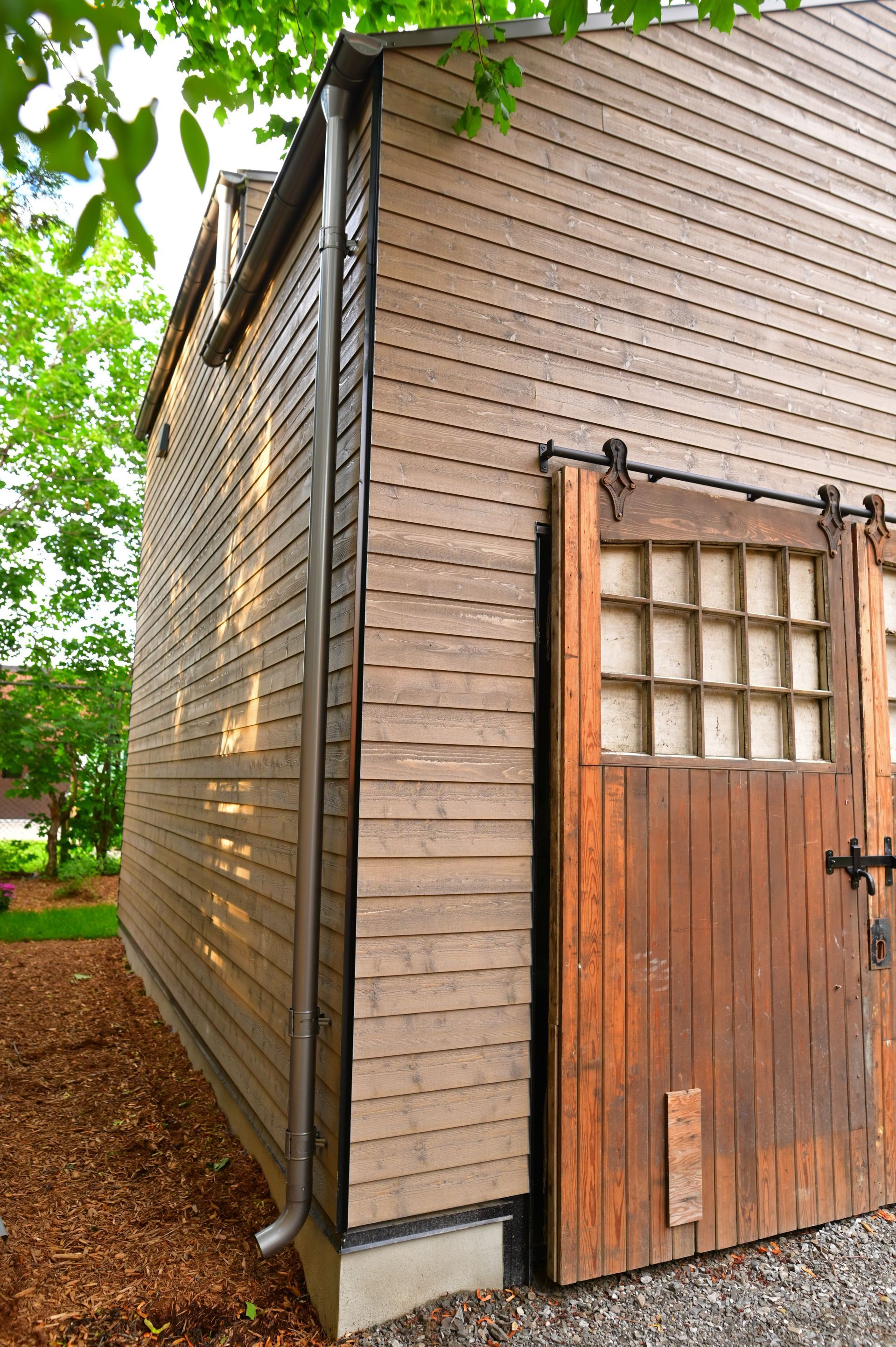 The side of a building with a sliding barn door.