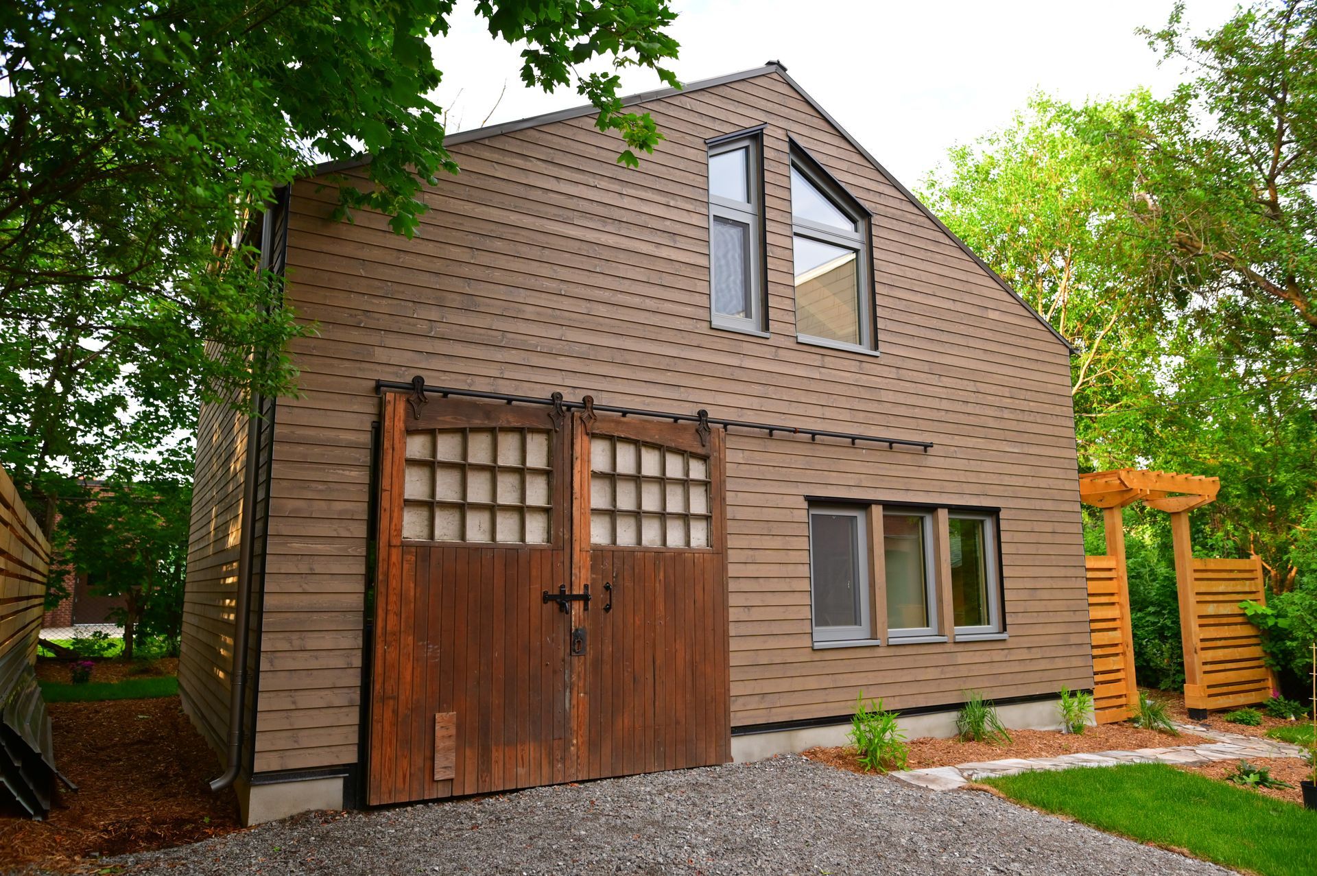 A brown house with a wooden garage door