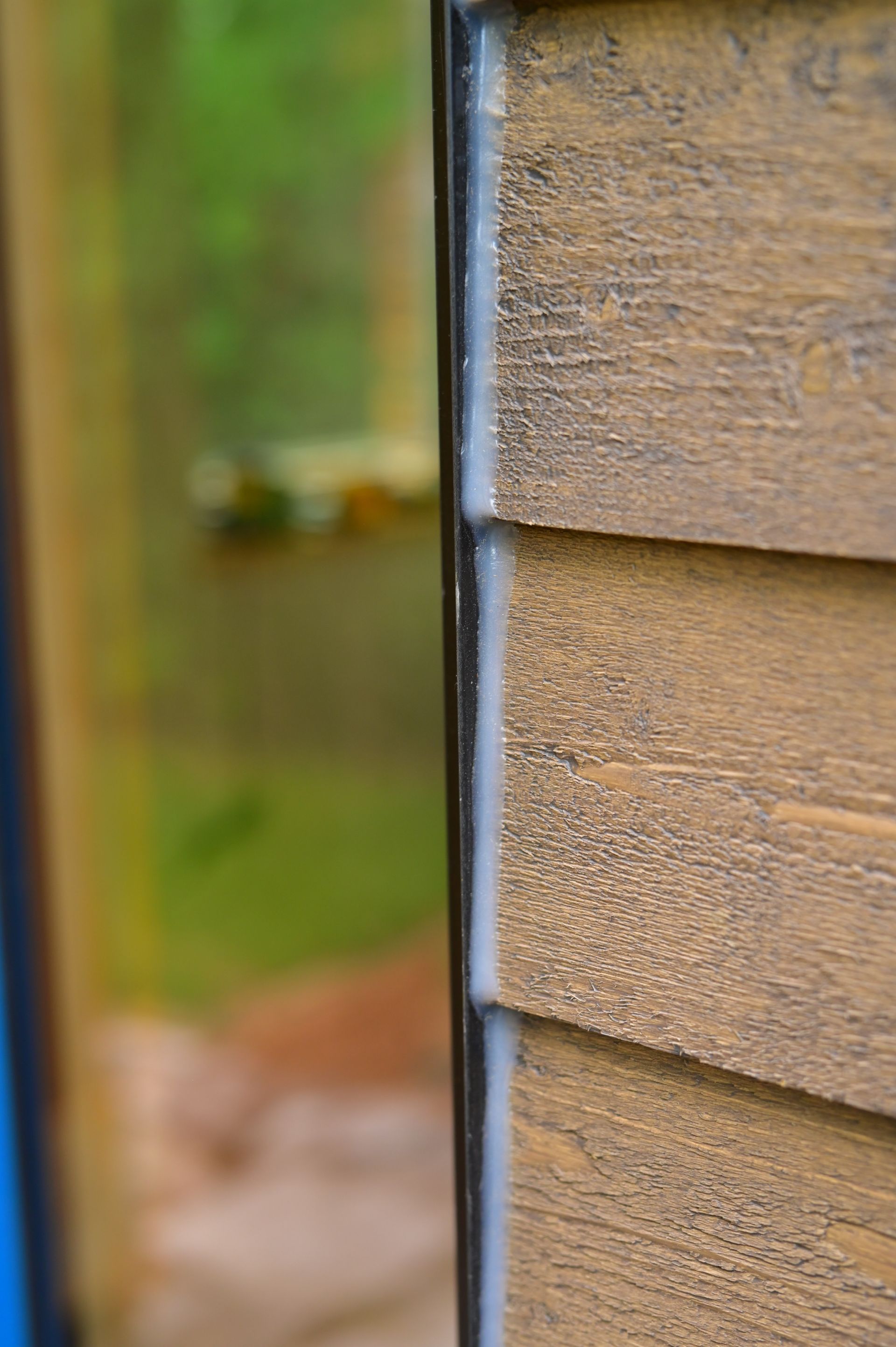 A close up of a wooden siding on a house.