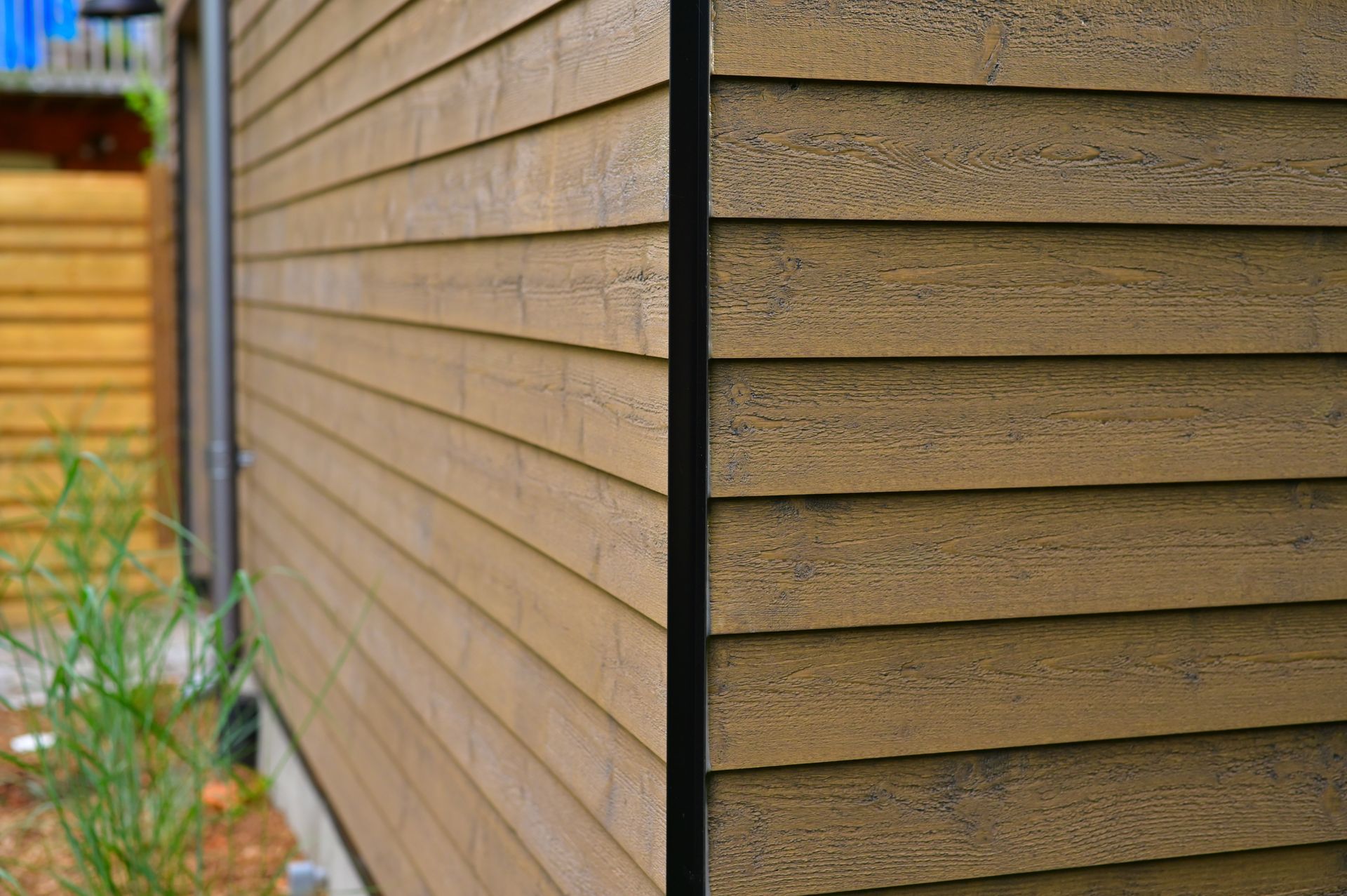 A close up of a wooden siding on the side of a house.
