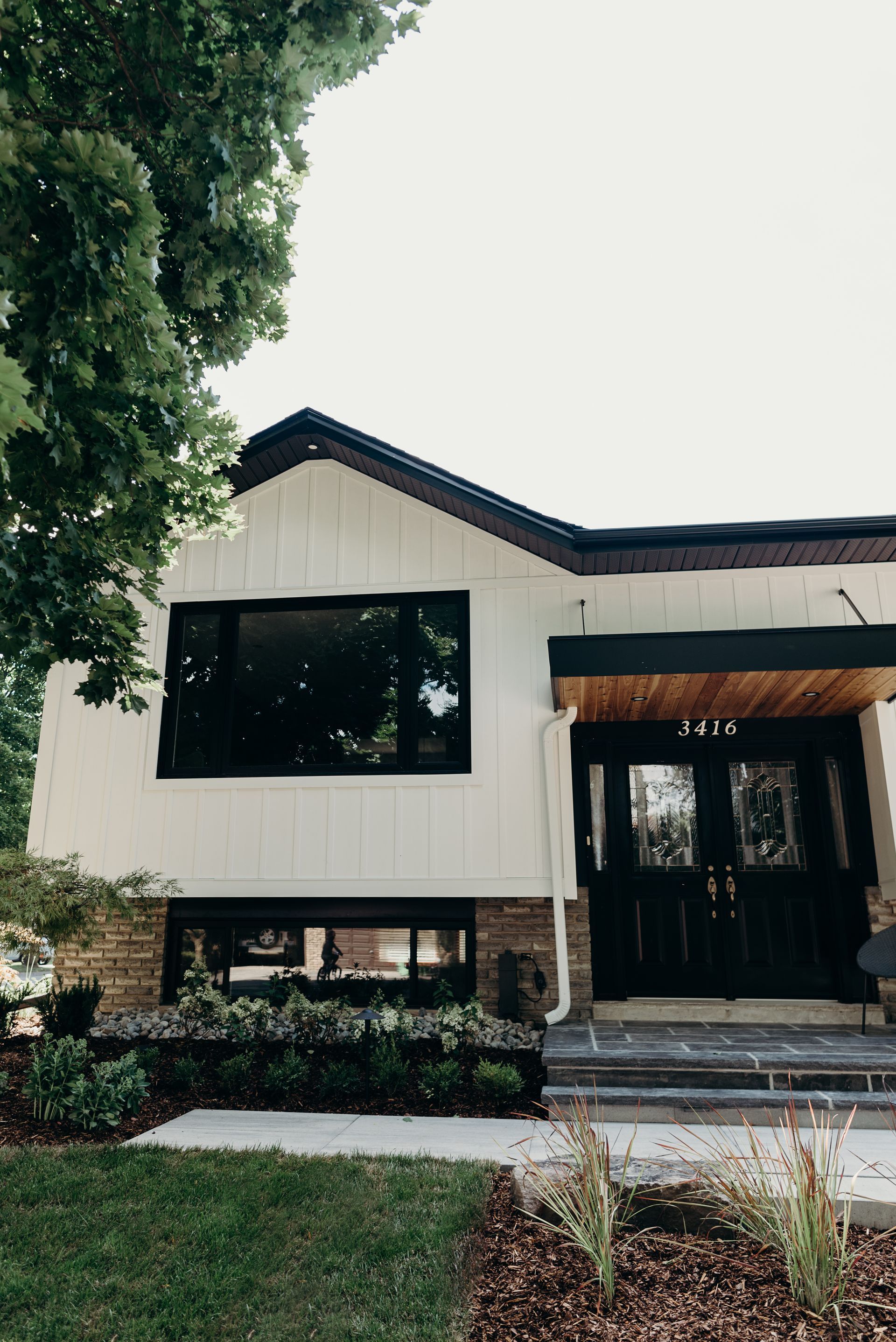 A white house with black windows and a black door.