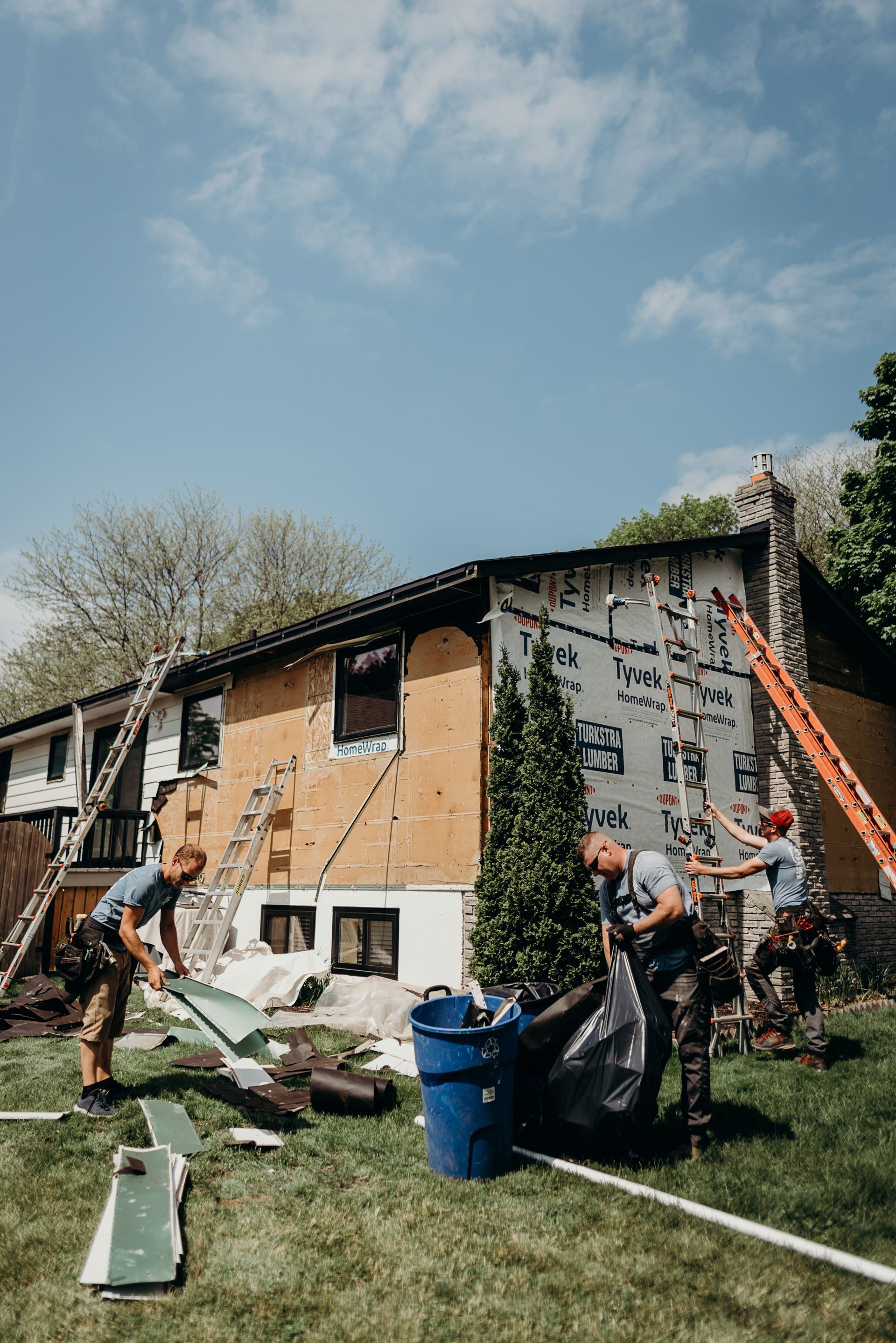 A group of men are working on a house.
