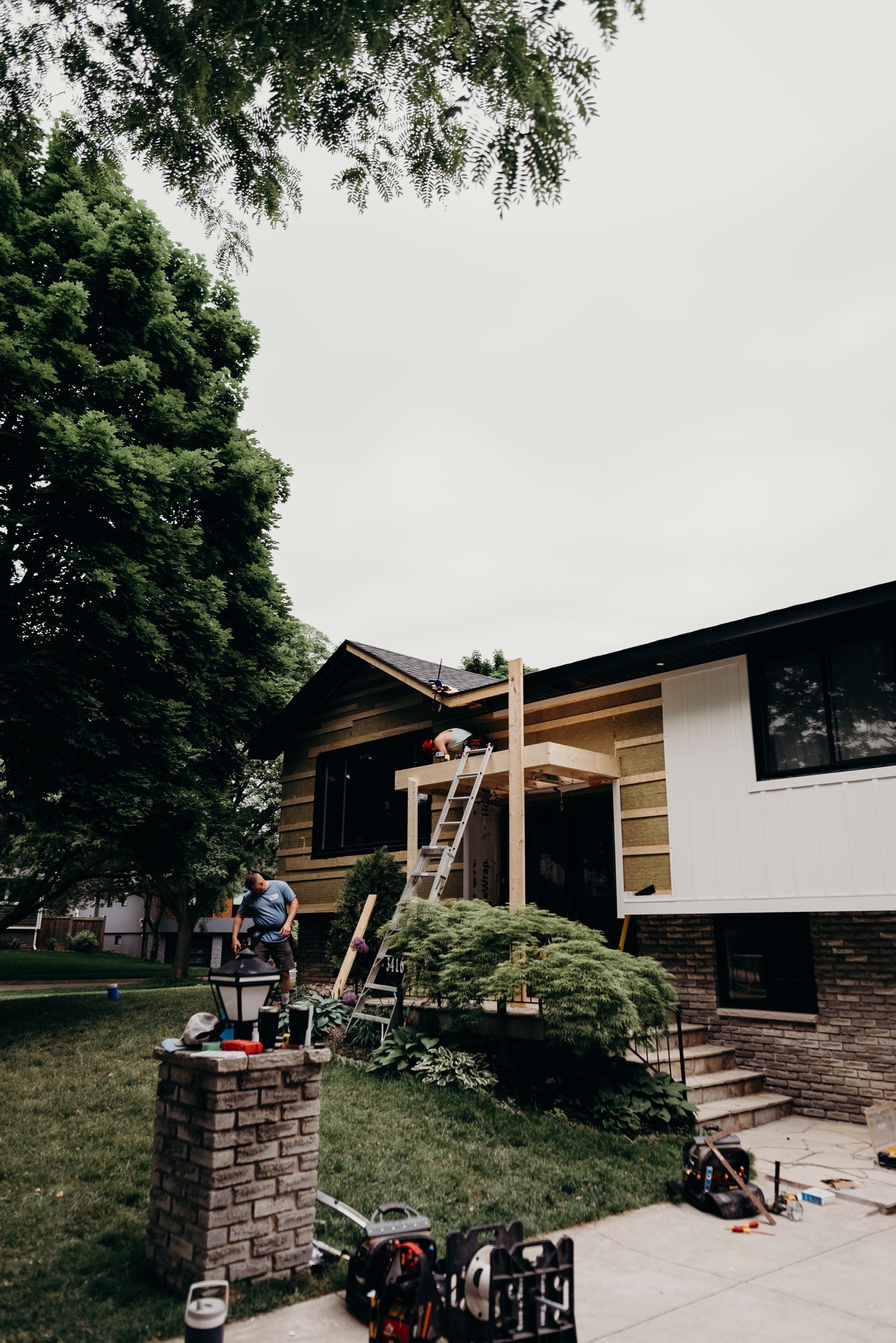 A house is being remodeled with a porch being built on top of it.