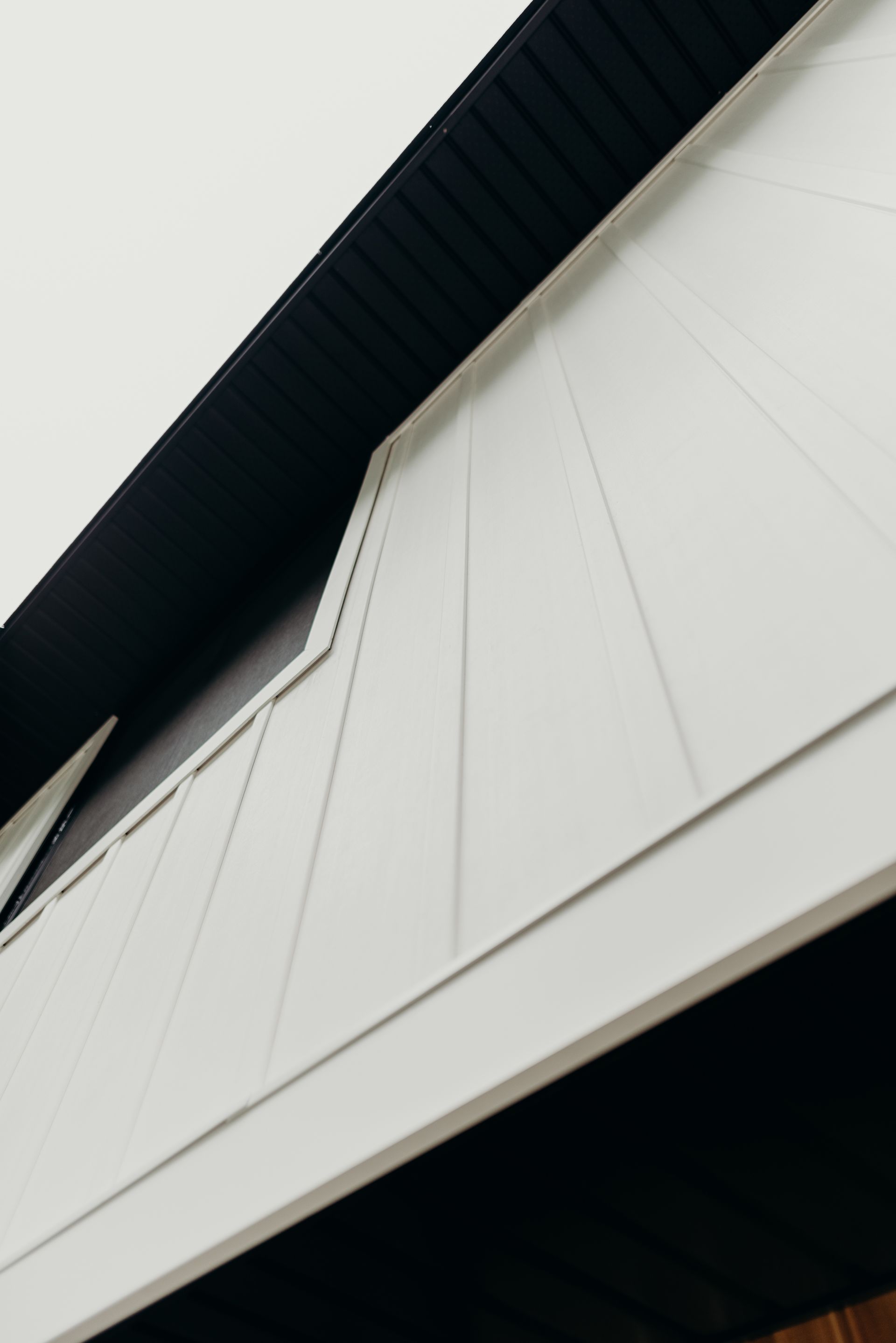 A close up of a white building with a black roof