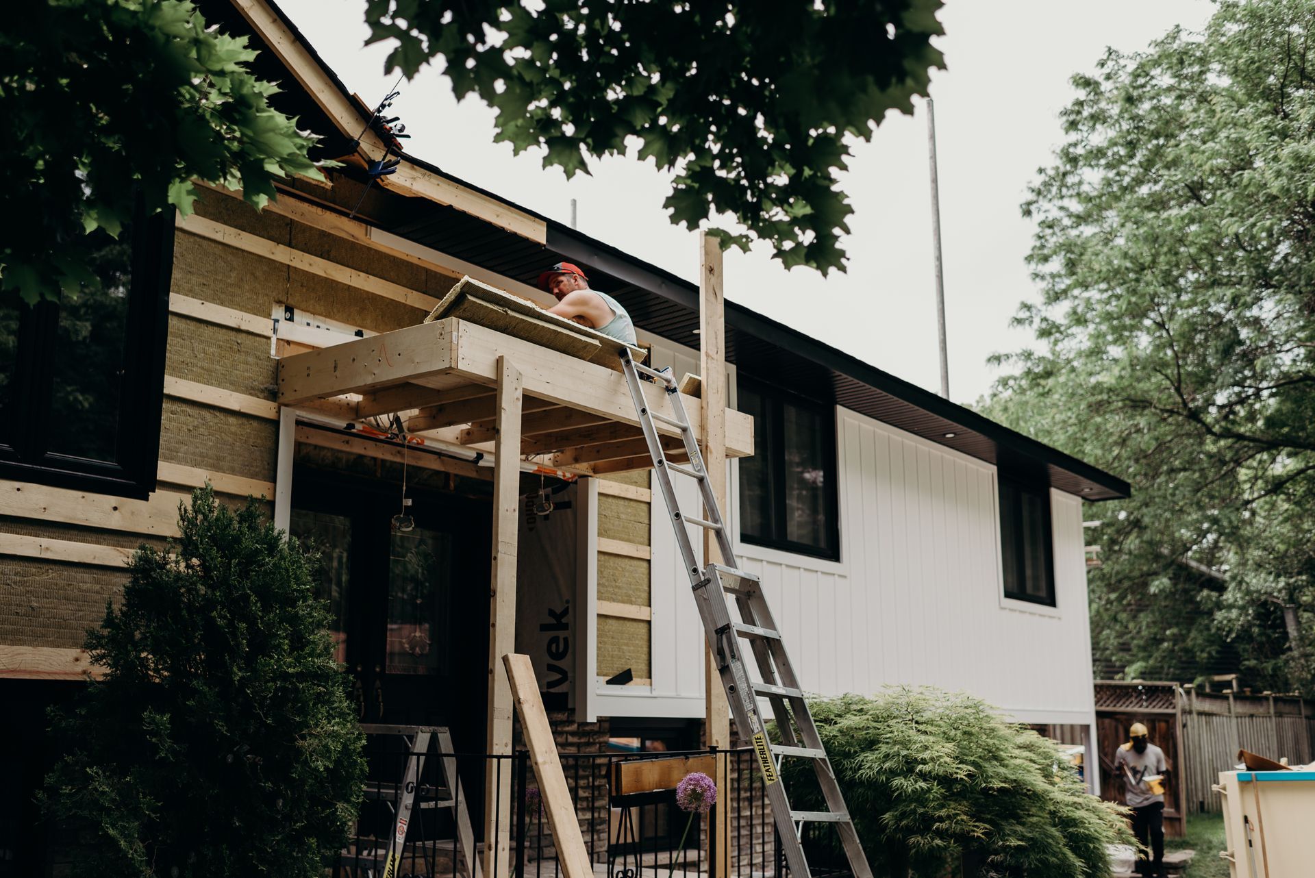 A man is working on the roof of a house.