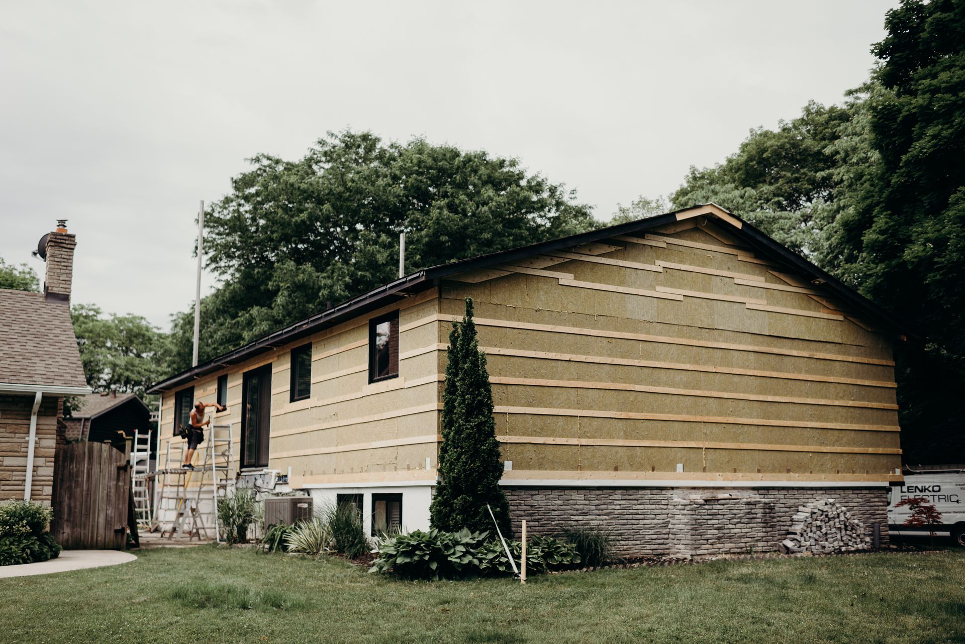 A house is being remodeled with a wooden siding.
