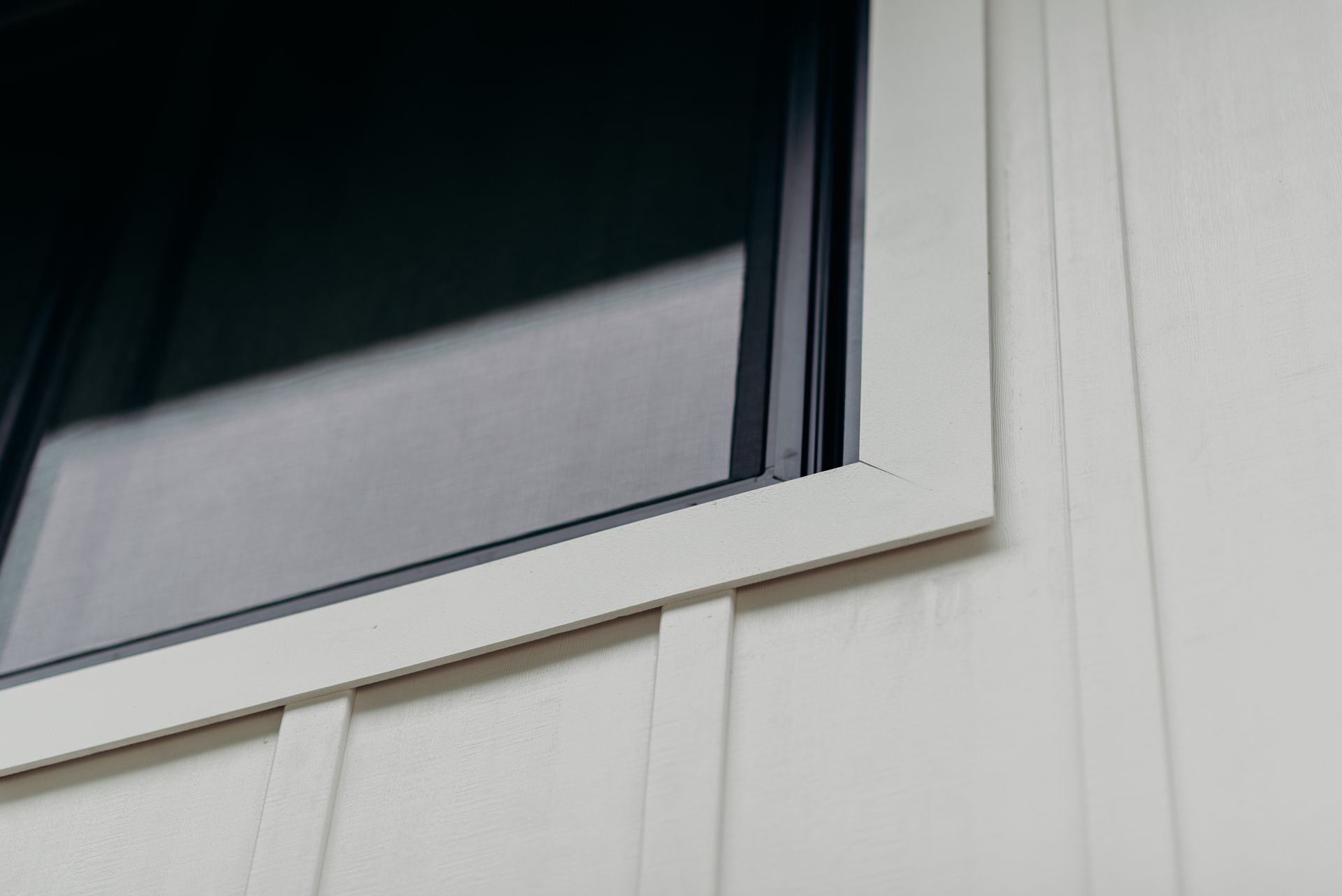 A close up of a window on a white house.