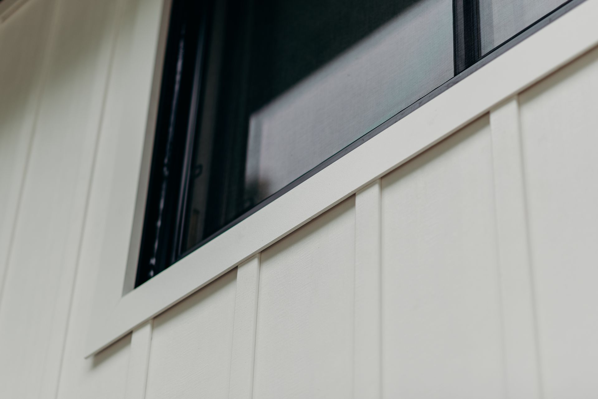 A close up of a window on a white house.