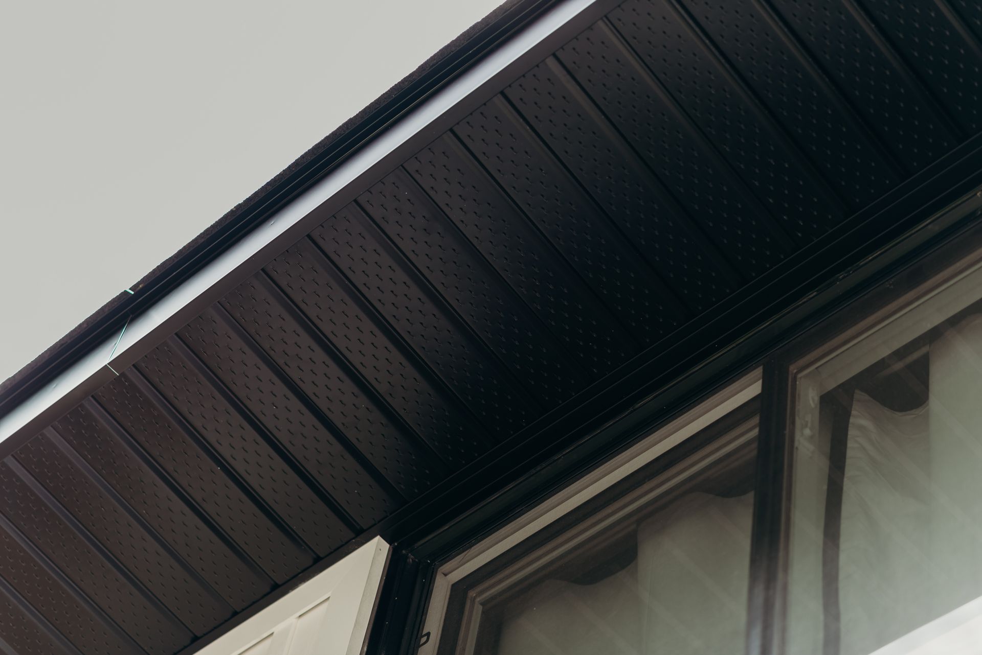 A close up of the roof of a building with a window