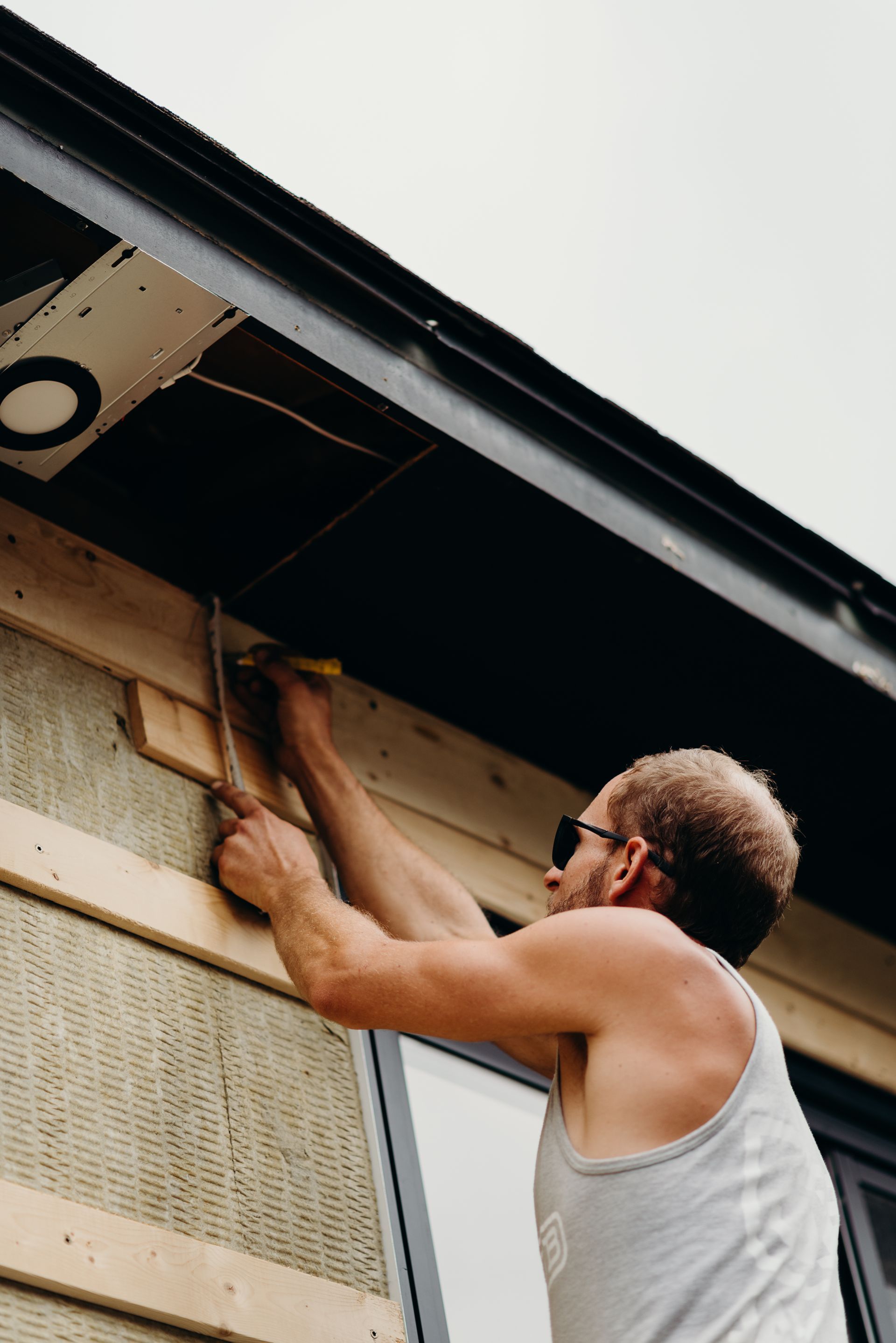 A man is working on the side of a building.