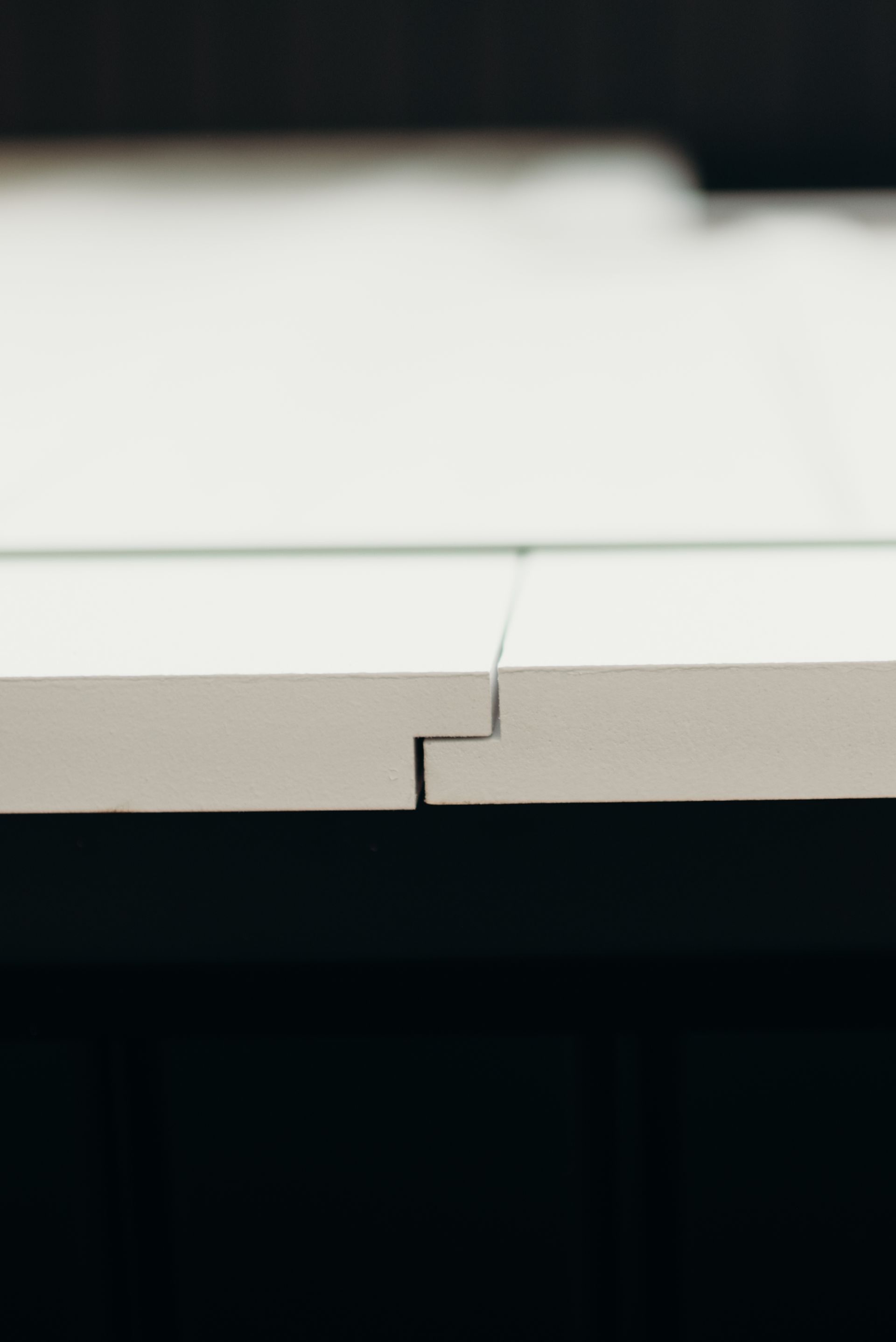 A close up of a piece of white wood on a table.