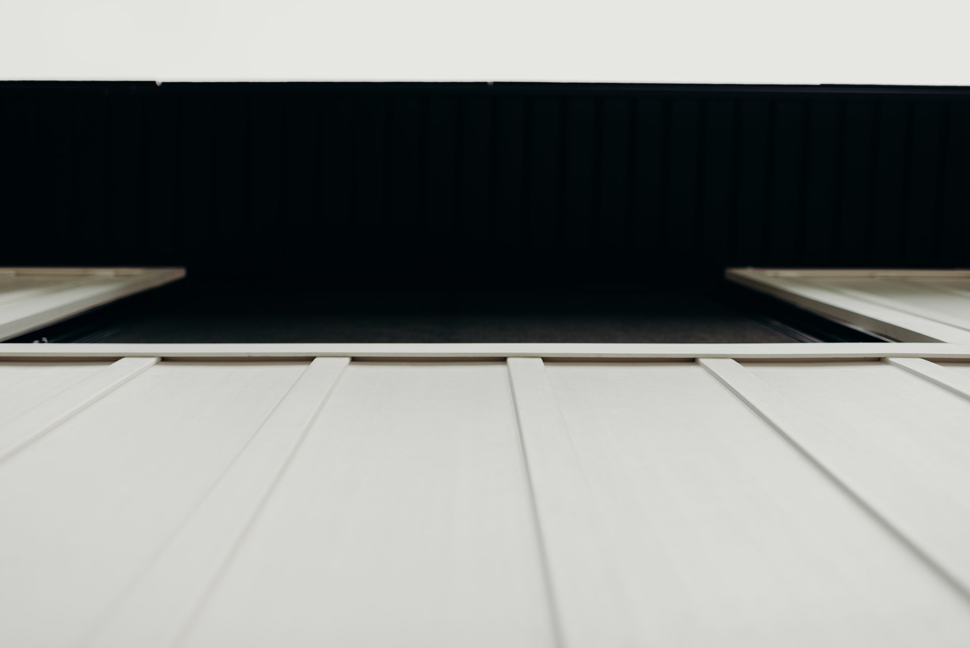 A close up of a white wall with a black background.