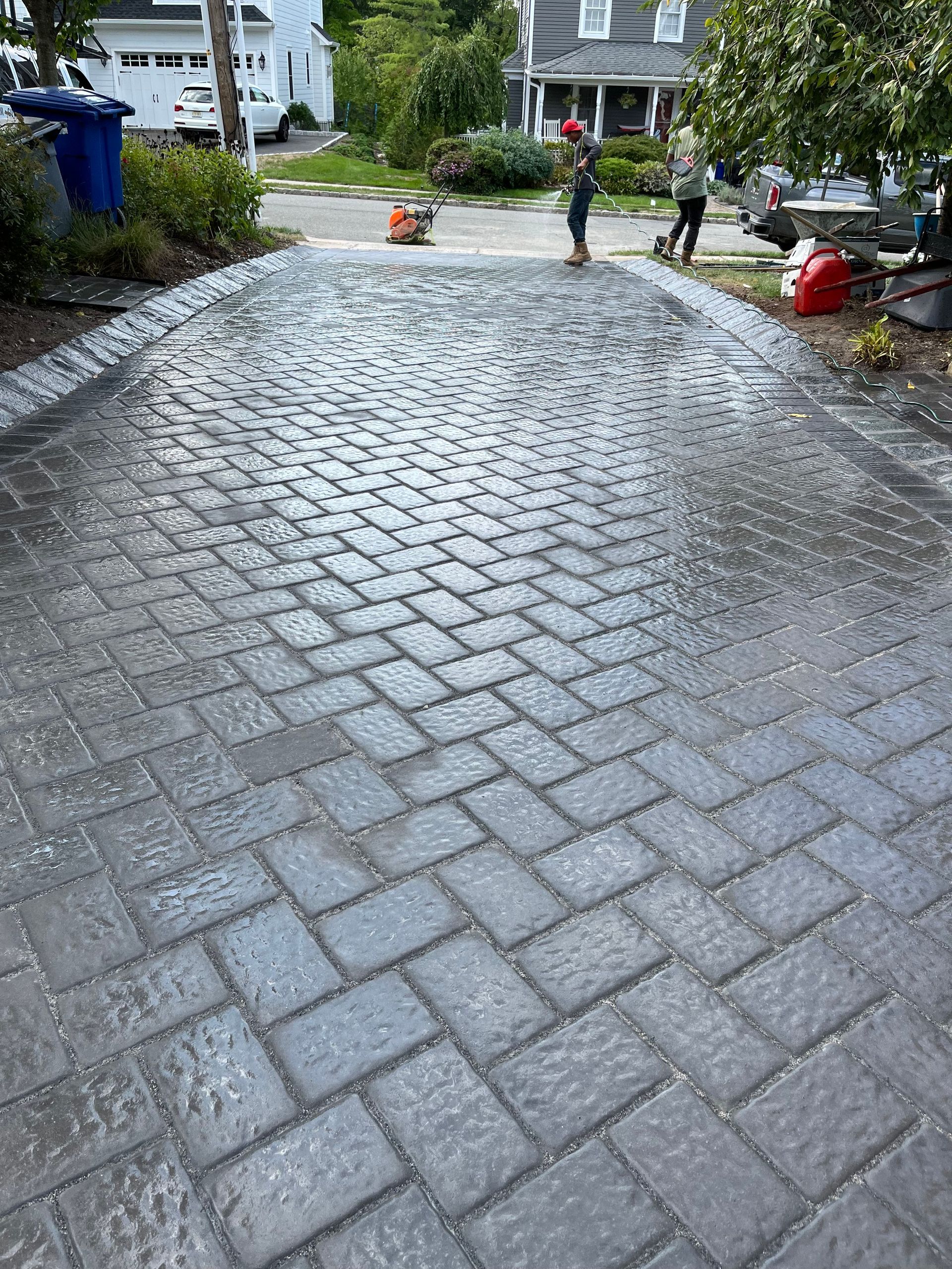 A stamped concrete driveway being installed.