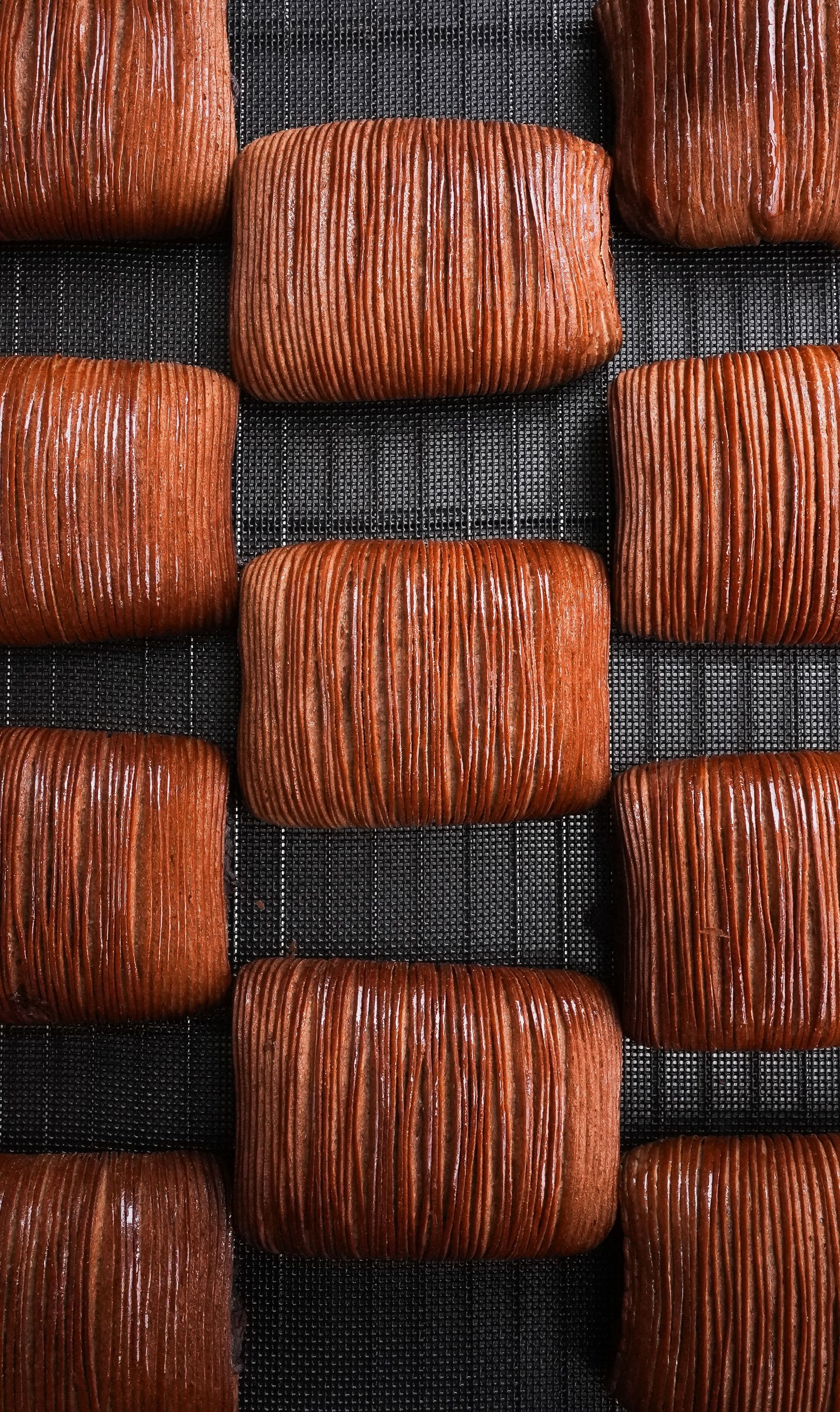 Un tas de barres de chocolat sont posées les unes sur les autres sur une grille de refroidissement.