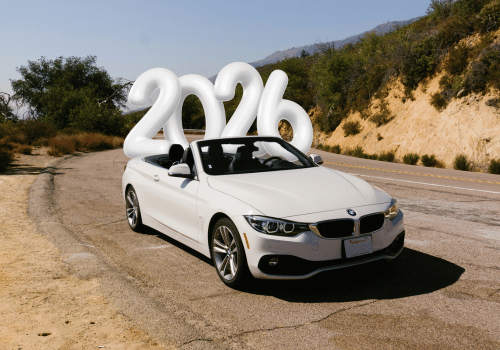 White convertible car on a winding road with inflatable 