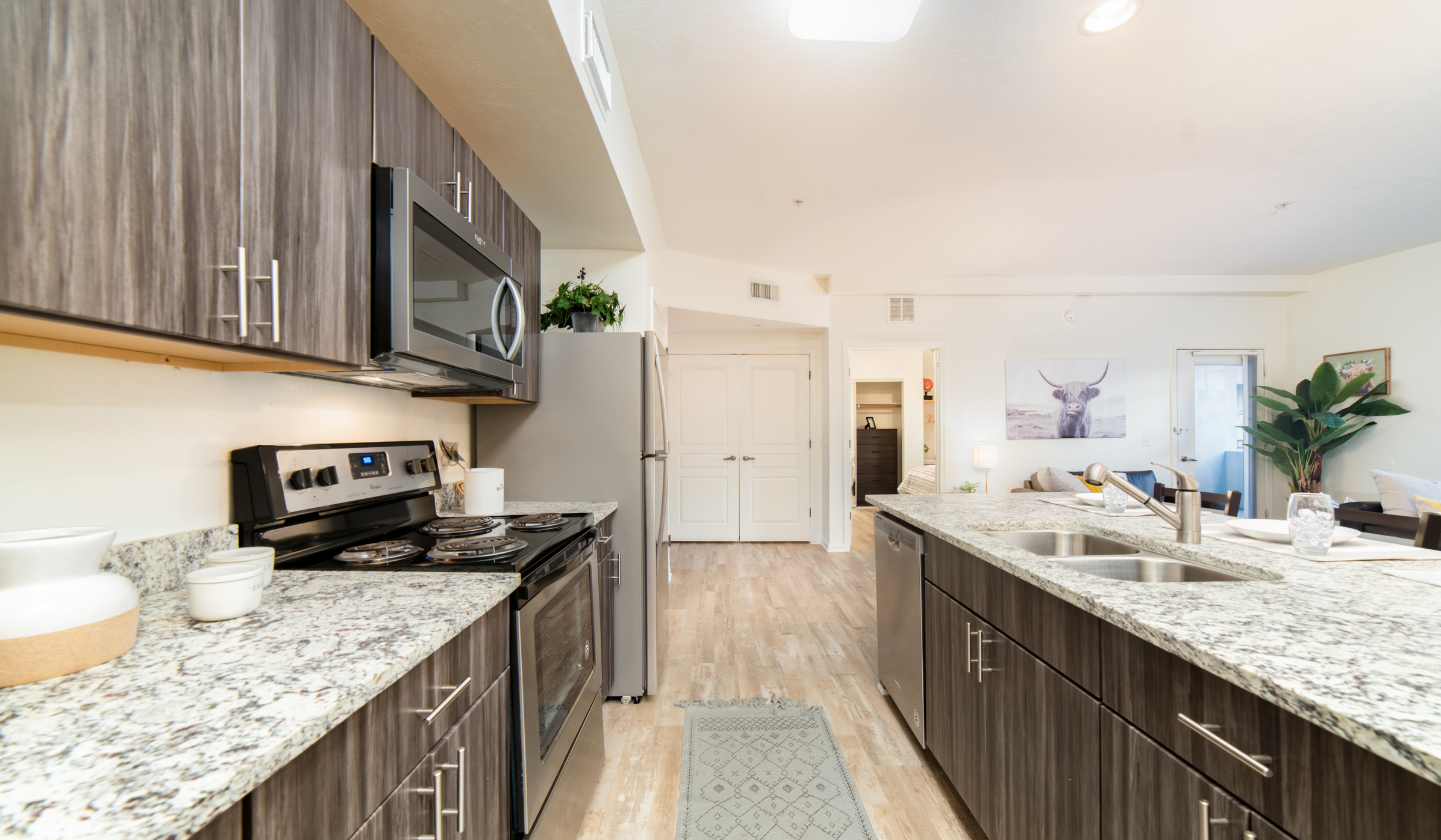 Apartment kitchen with updated stainless steel appliances.