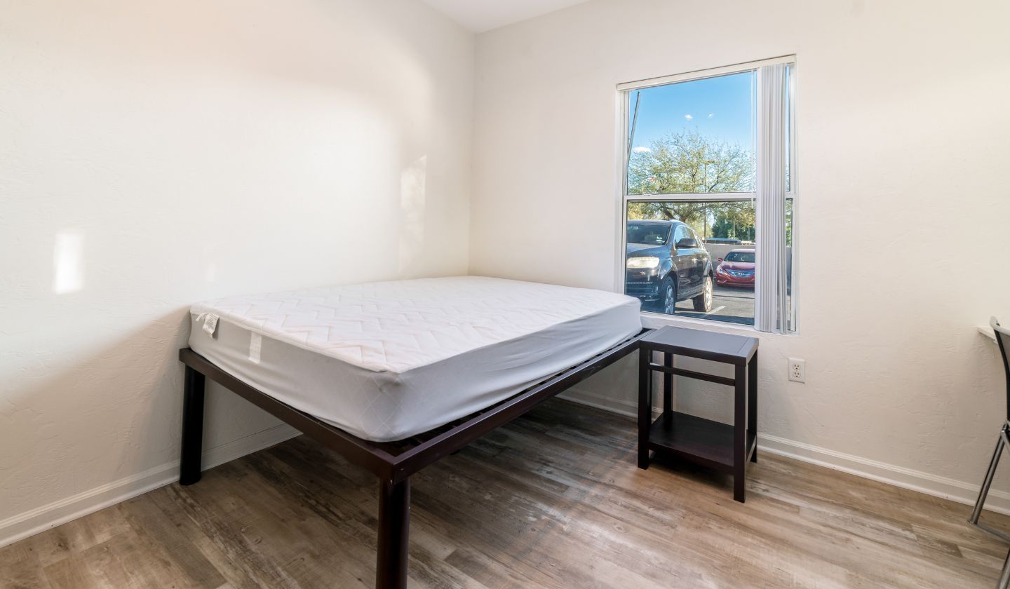 Furnished bedroom with no decorations.