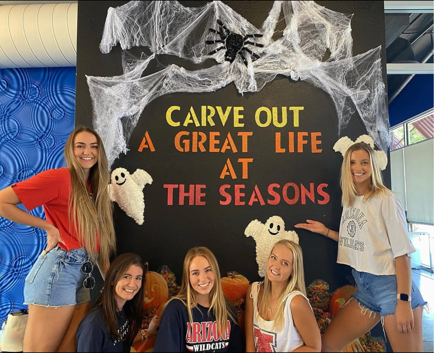 Female residents hanging in the Halloween decorated Clubhouse at the Seasons.