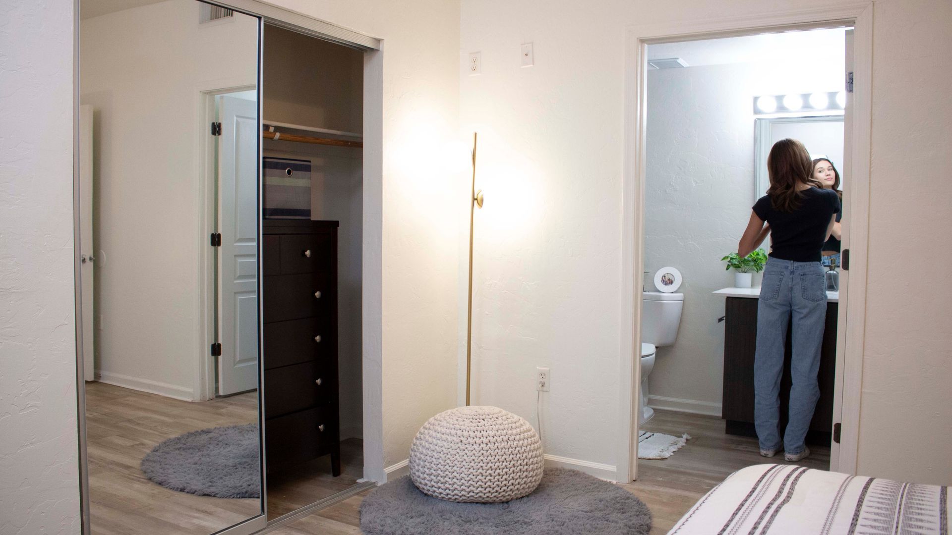 Female resident doing their makeup in their private bathroom.
