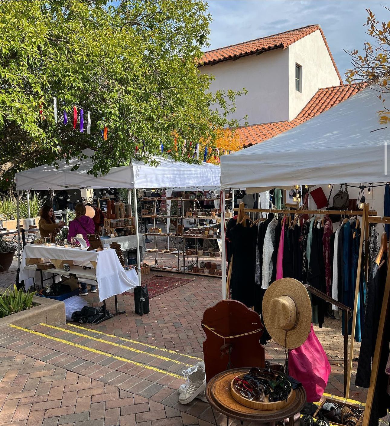 Small businesses showcase handmade jewelry, art, and clothing for shoppers at the Mercado San Agustin.