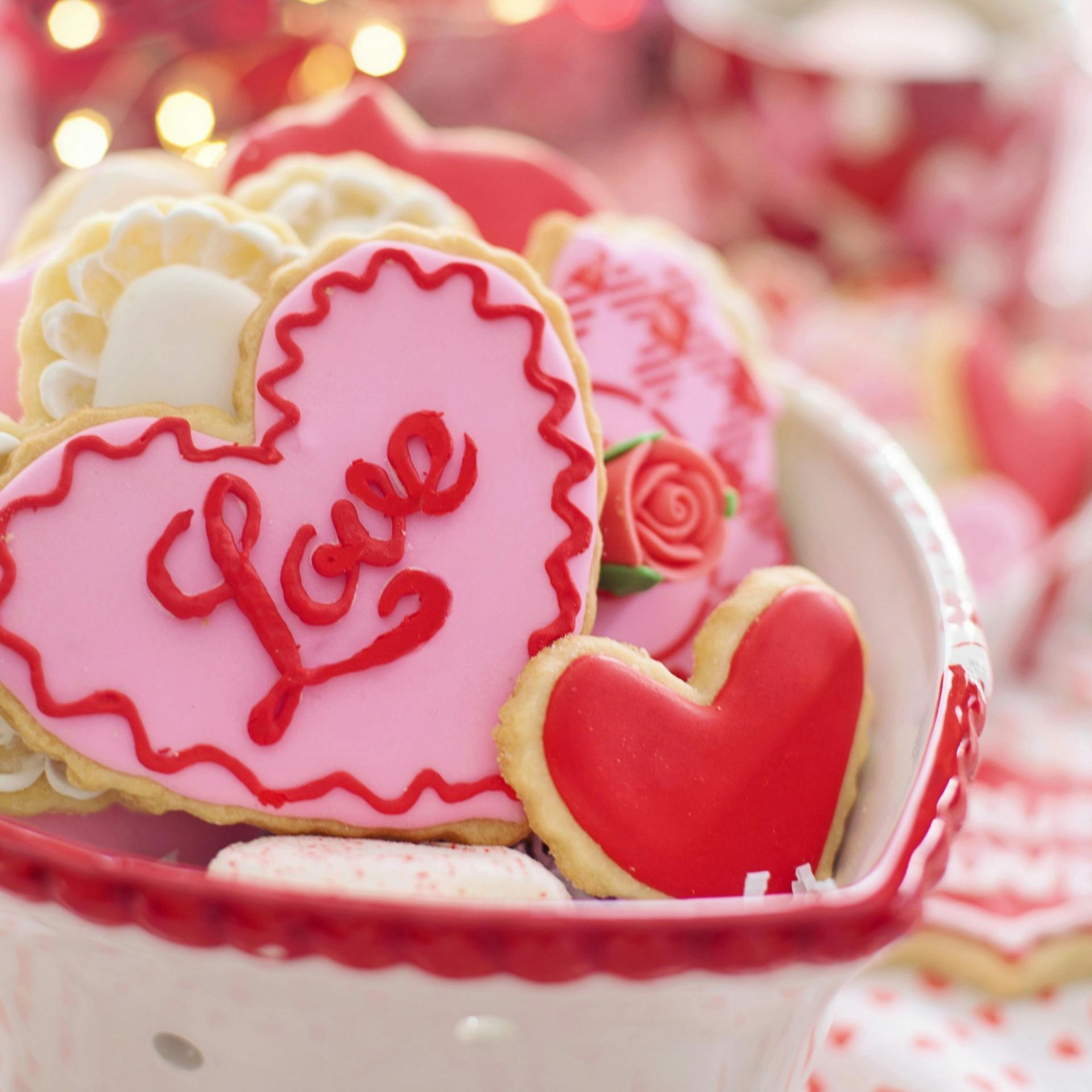 Heart-shaped treats decorated with pink, red, and white icing.