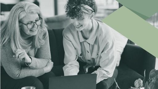 Group on surfboards at beach, some cheering. Blue sky, water, and sand.