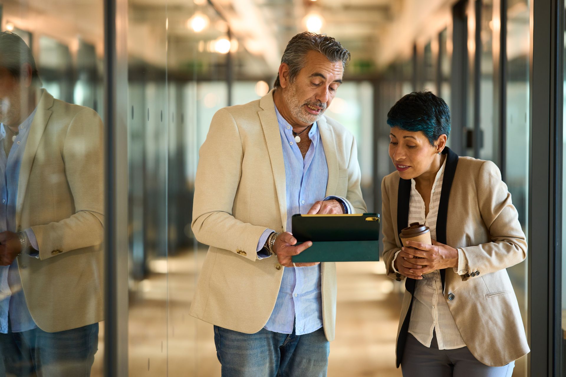 Group of people with hands together, teamwork and collaboration in an office setting.