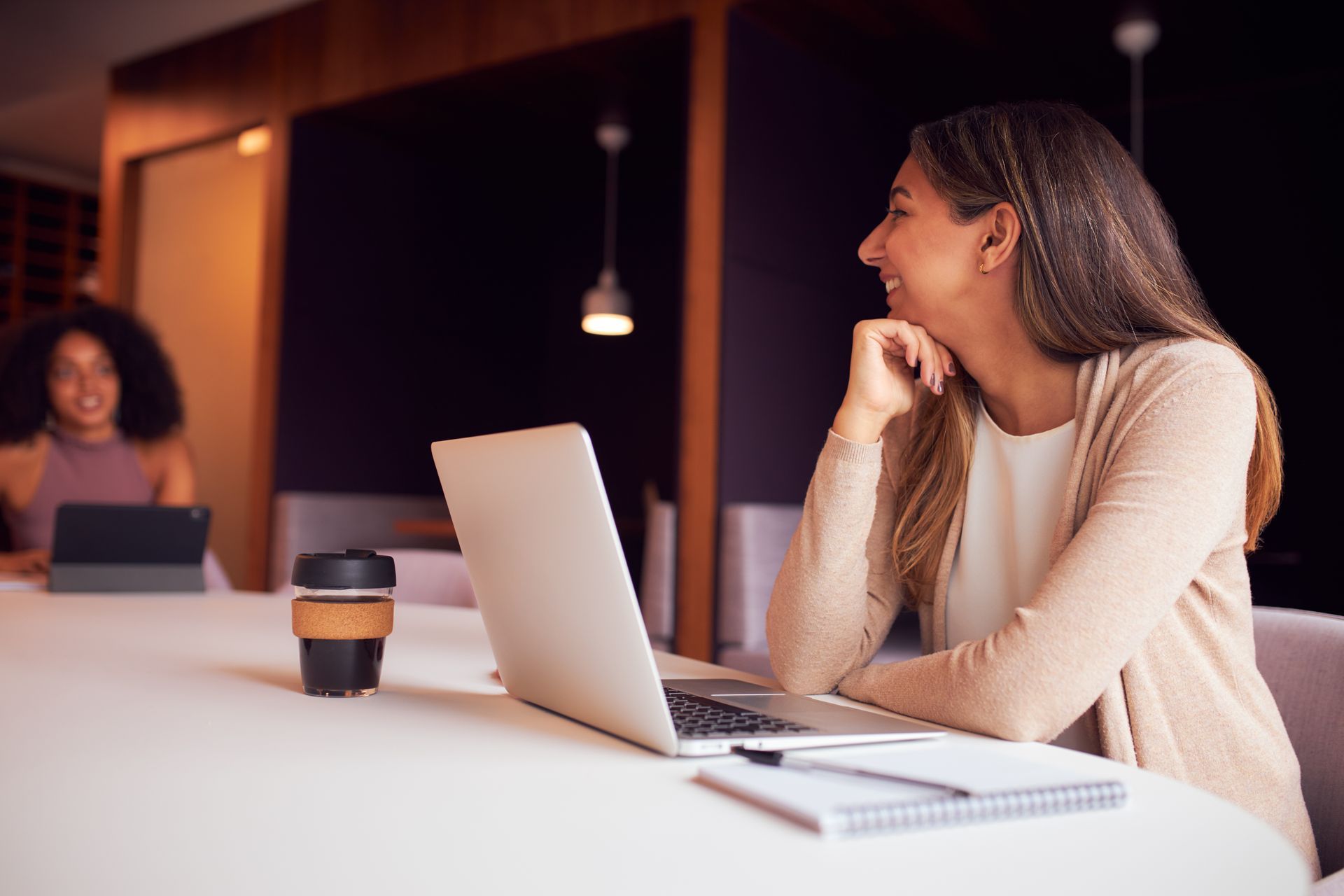 Group of people with hands together, teamwork and collaboration in an office setting.