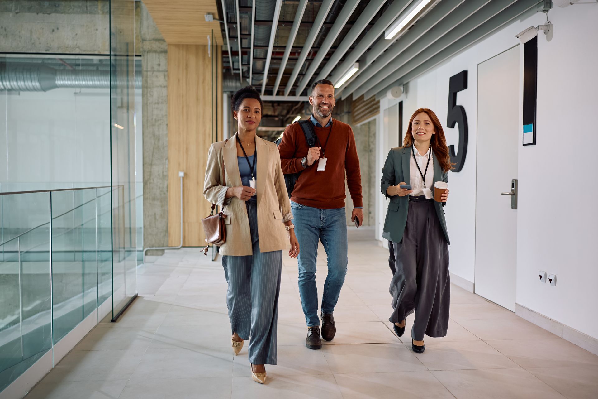 Group of people with hands together, teamwork and collaboration in an office setting.