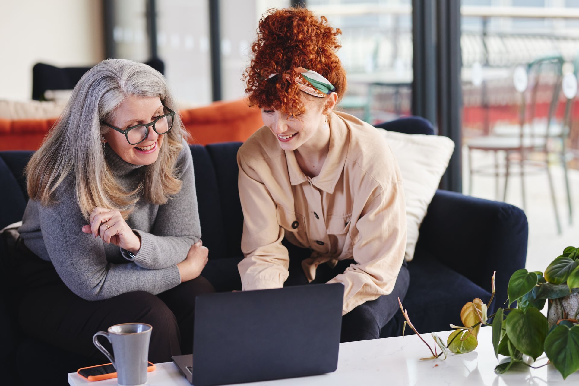 Group of people with hands together, teamwork and collaboration in an office setting.